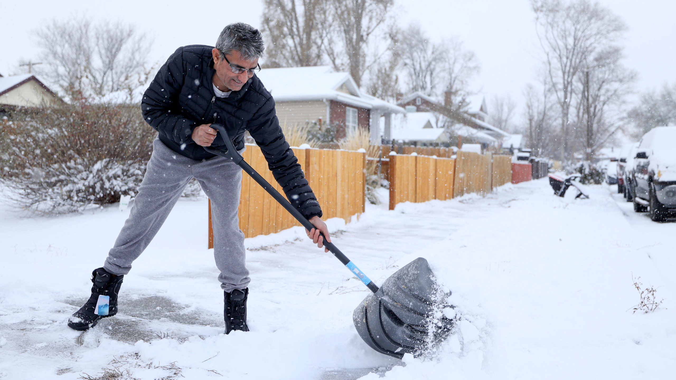 Hari Bastakoti shovels a sidewalk following a snowstorm in Salt Lake City on Tuesday, Nov. 29, 2022...