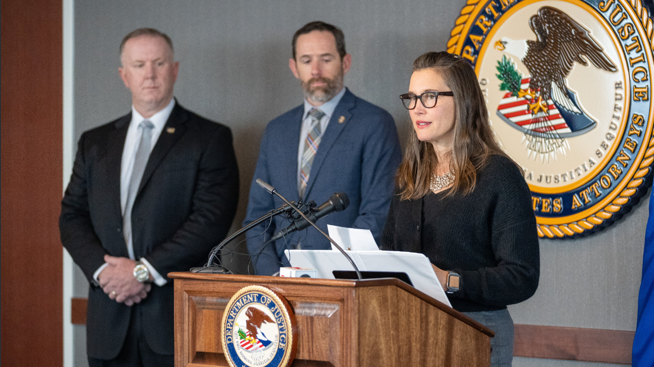 Erin mendenhall and two men are pictured at a podium speaking about crime statistics in salt lake...