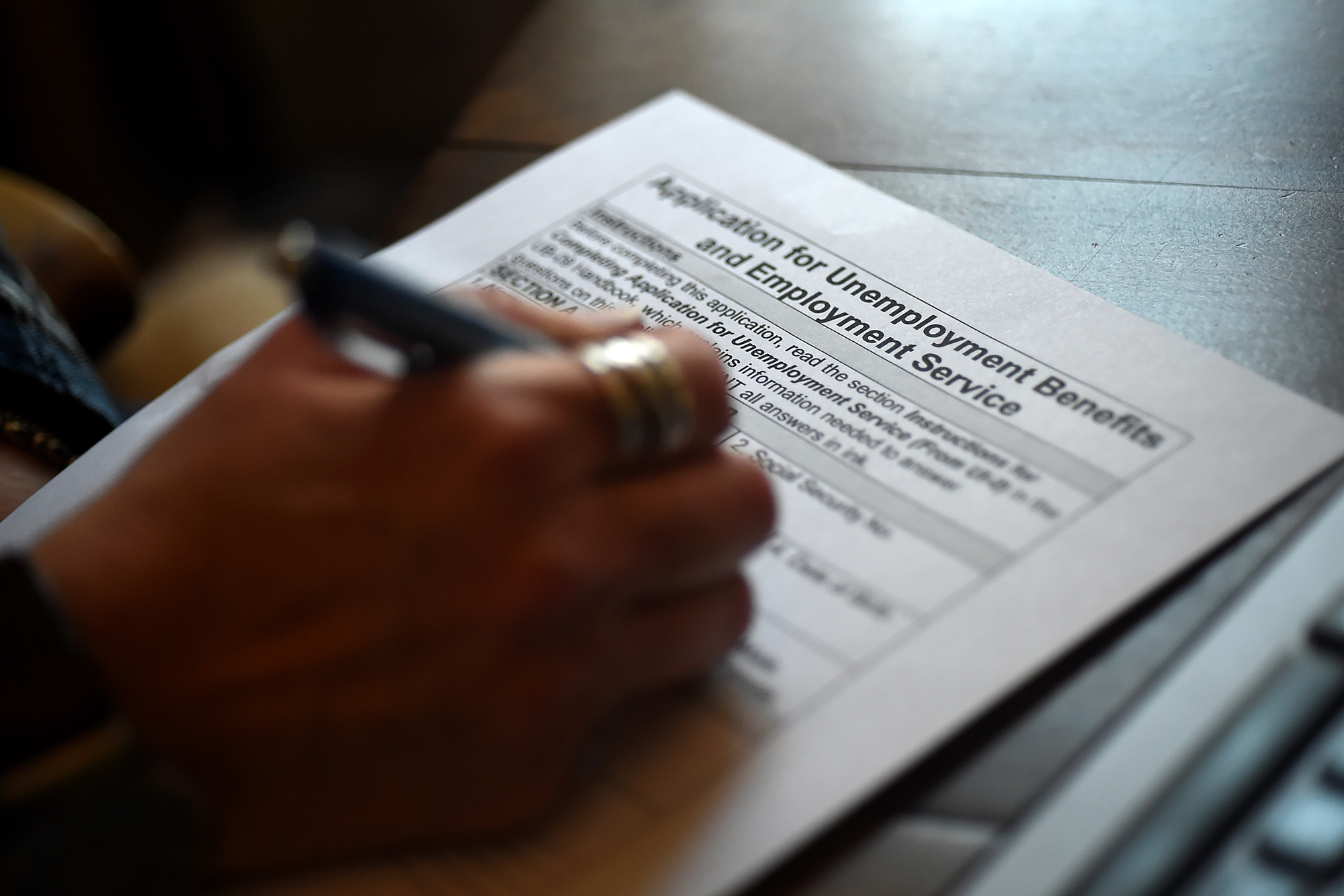 In this photo illustration, a person files an application for unemployment benefits on April 16, 20...