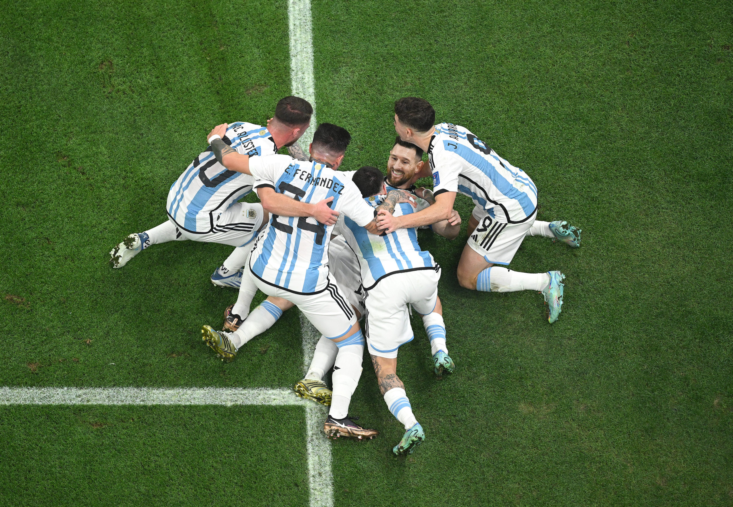 LUSAIL CITY, QATAR - DECEMBER 18: Lionel Messi of Argentina celebrates with teammates after scoring...