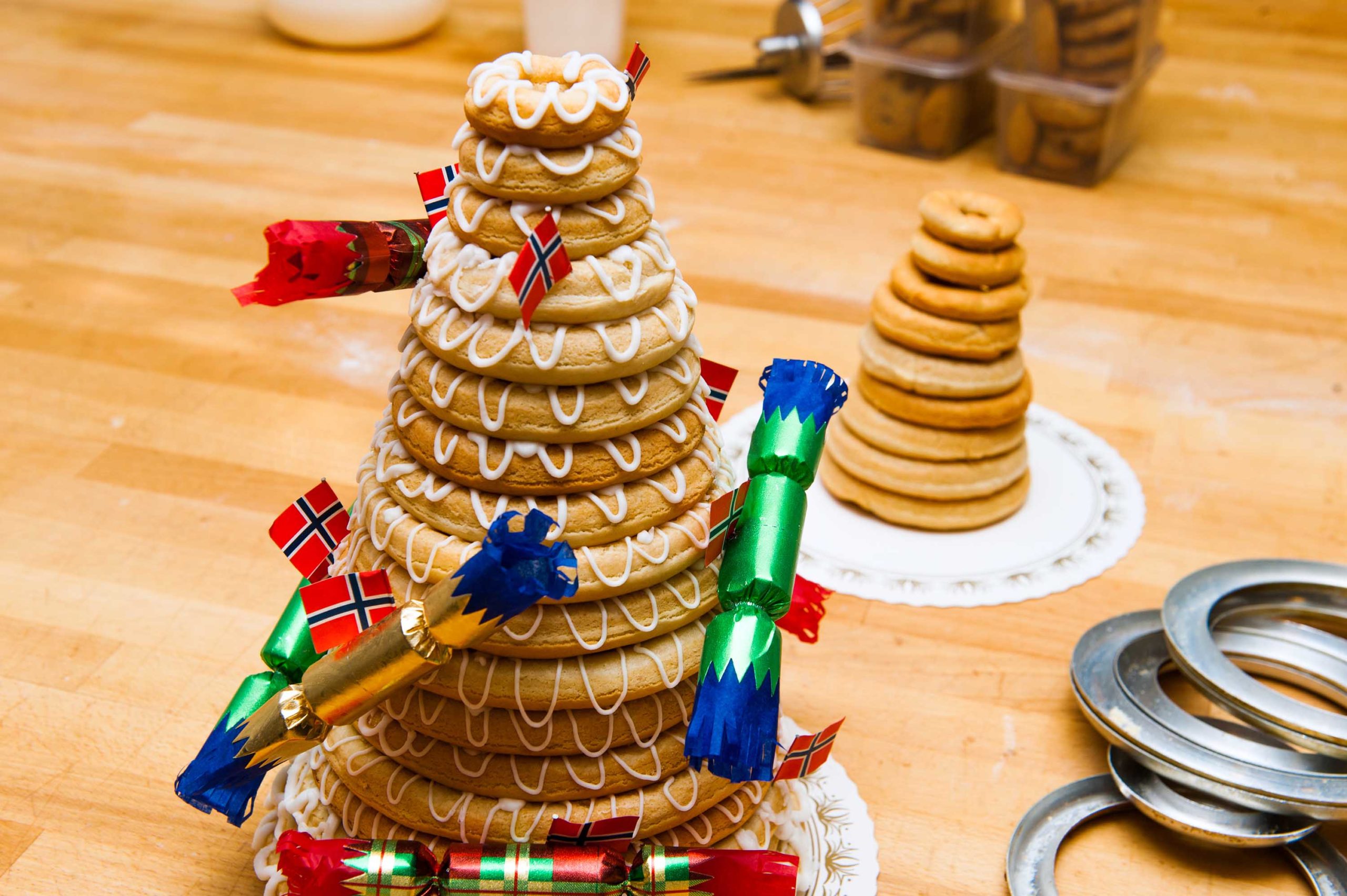 Traditional Norwegian marzipan ring cake - kransekake - seen from side with cracker  and Norwegian ...