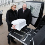 Mary Taylor carries a symbolic baby casket to a hearse during a Pro-Life Utah memorial at the Capitol in Salt Lake City.