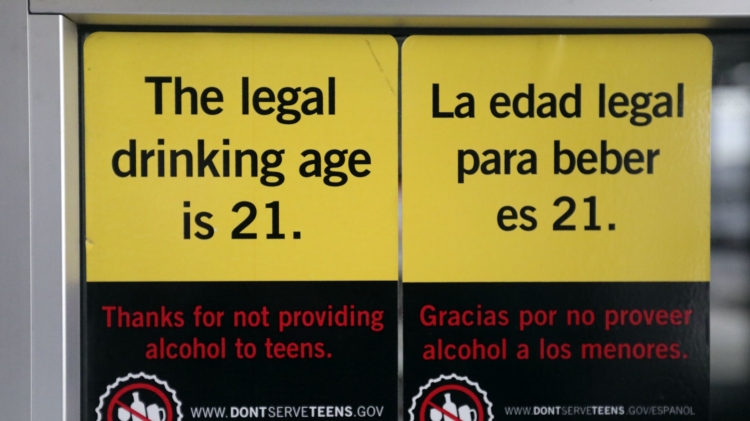 A sticker on the door to a state liquor store in Salt Lake City shows the legal drinking age on Fri...