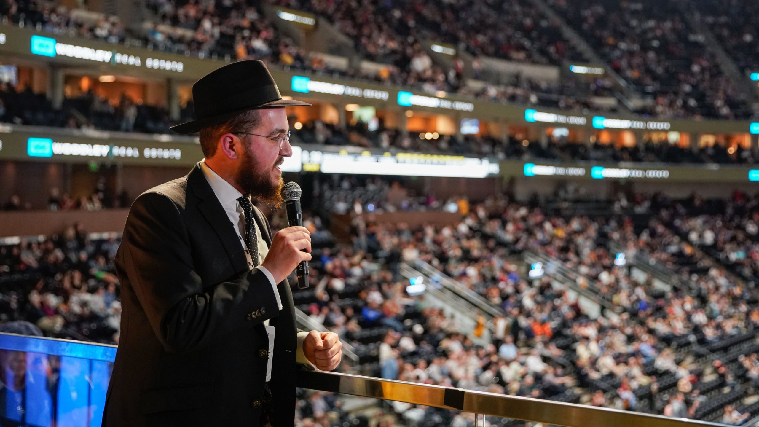Rabbi Avremi Zippel talks to the crowd during halftime of a Jazz-Portland Trail Blazers game at Viv...