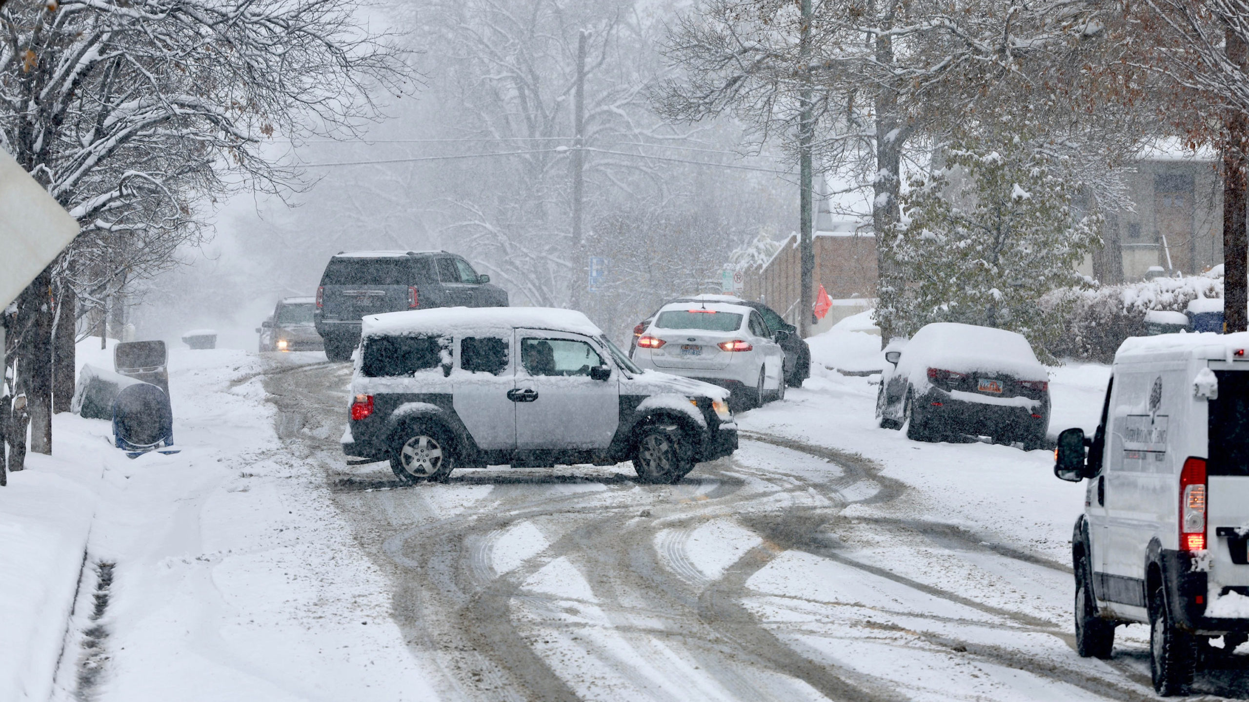 Cars spinning out on a snowy Utah road. Preparing your vehicle for winter helps keep Utah roads saf...