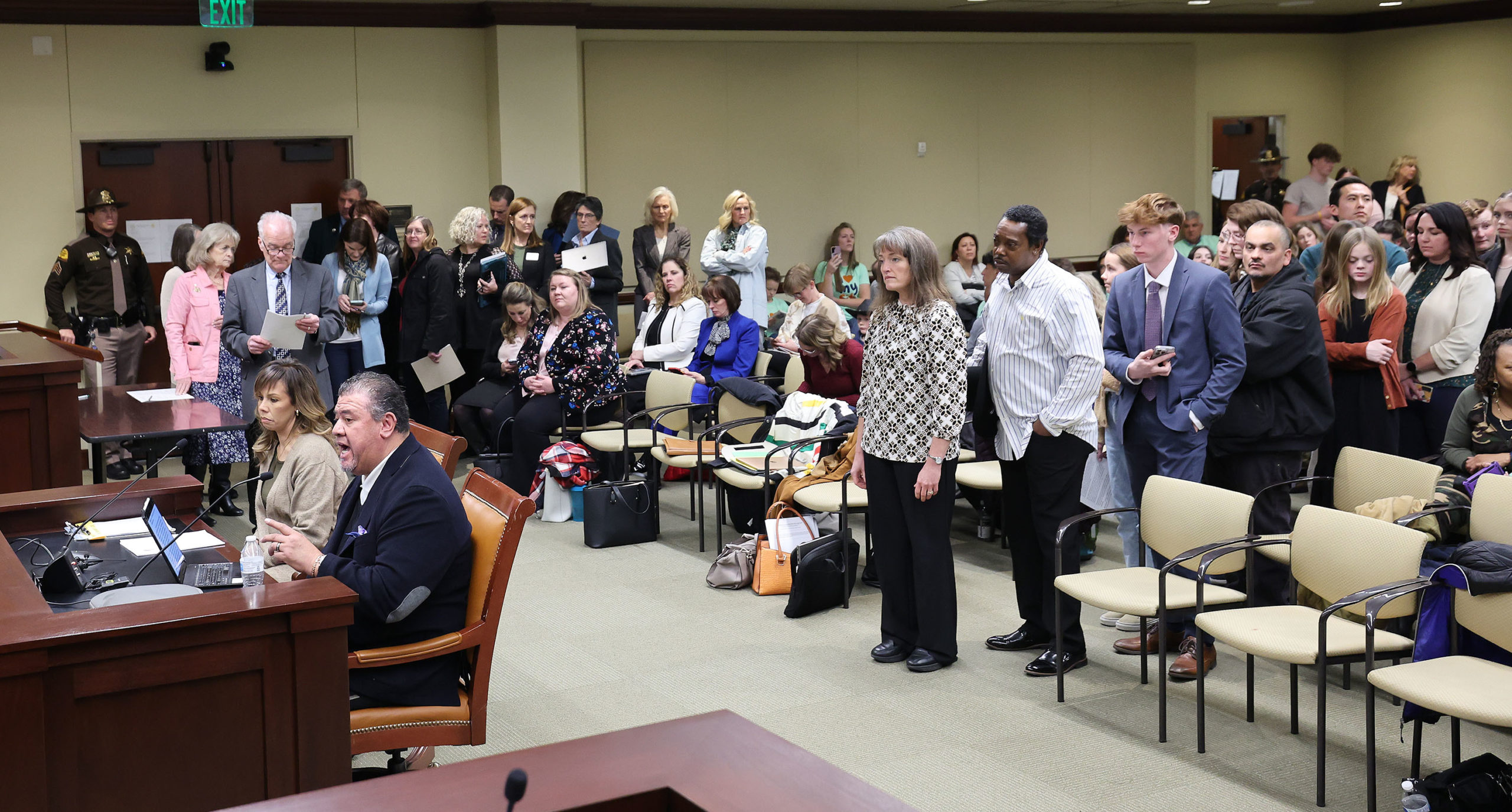 Members of the public line up for comment during a House Education Committee hearing on HB215 at th...
