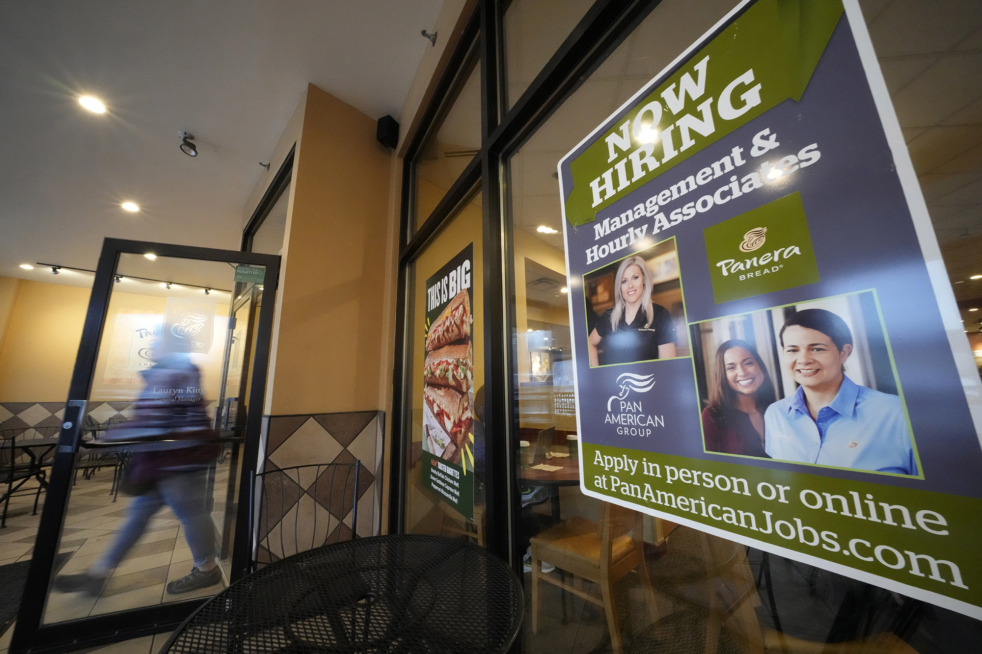 A hiring sign is displayed in the window of a Panera Bread store in Pittsburgh on Monday, Jan. 23, ...