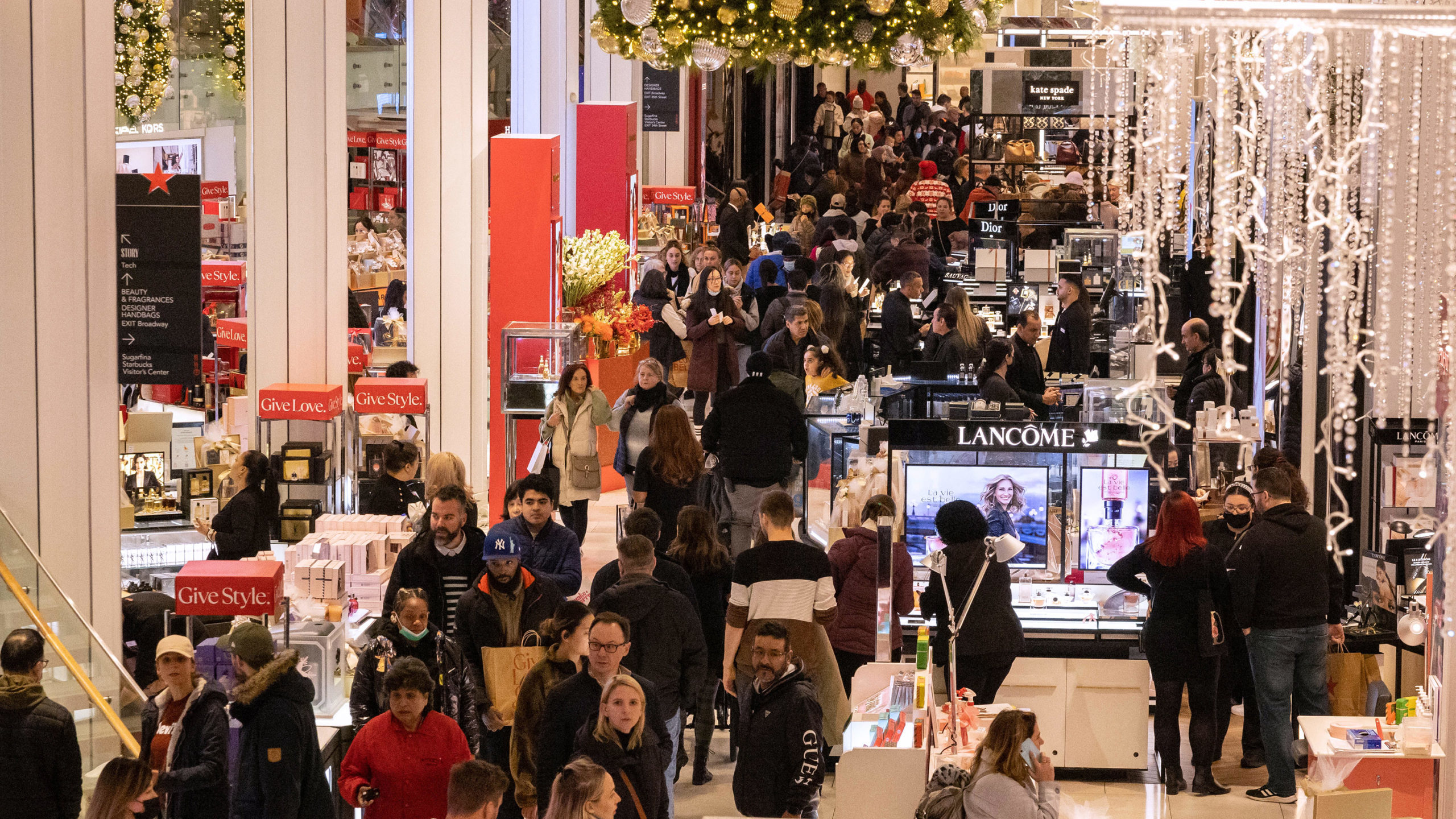 People shop at Macy's department store during Black Friday in New York City on November 25, 2022....