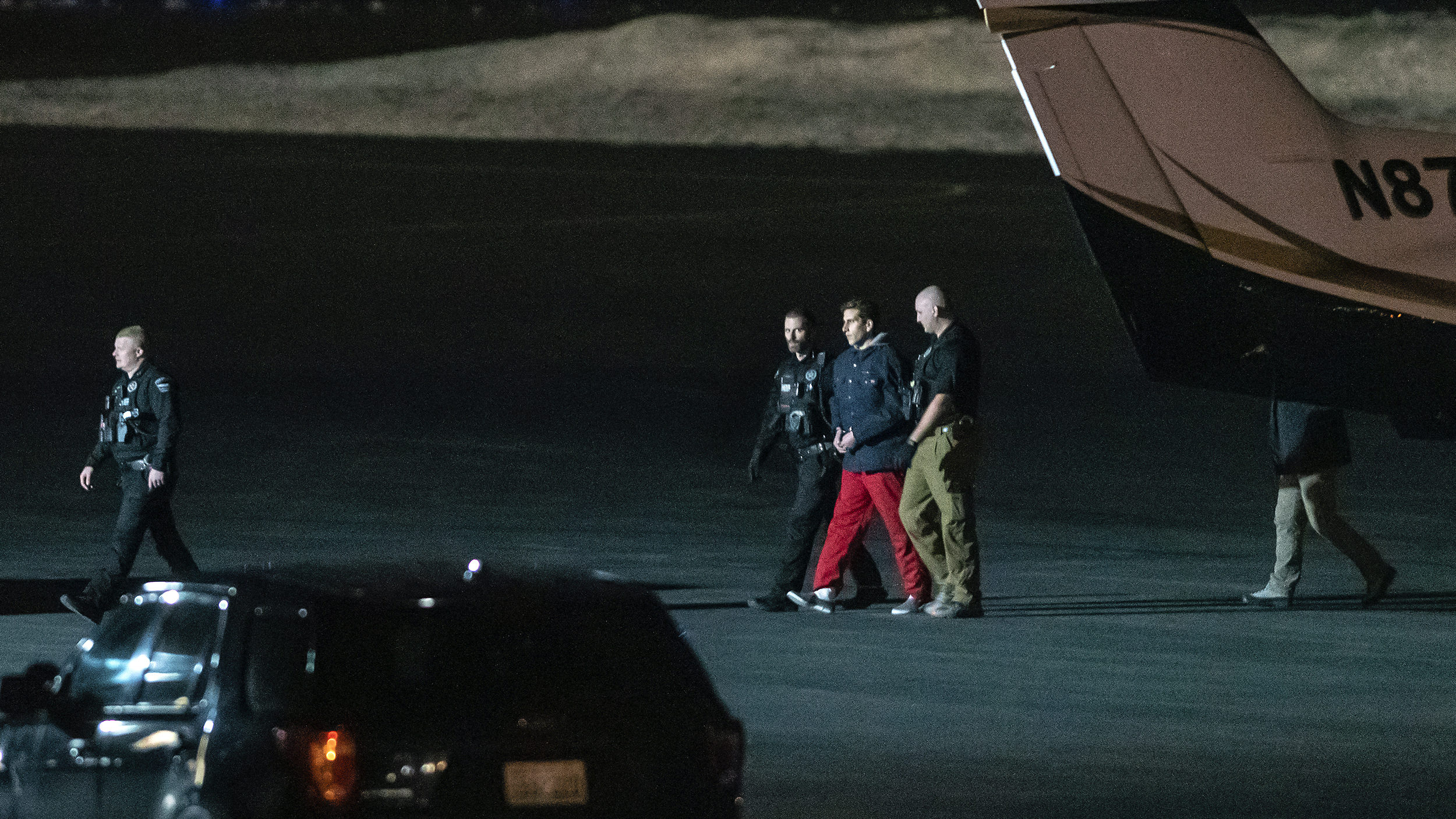 Bryan Kohberger is escorted by law enforcement after arriving at Pullman-Moscow Regional Airport on...