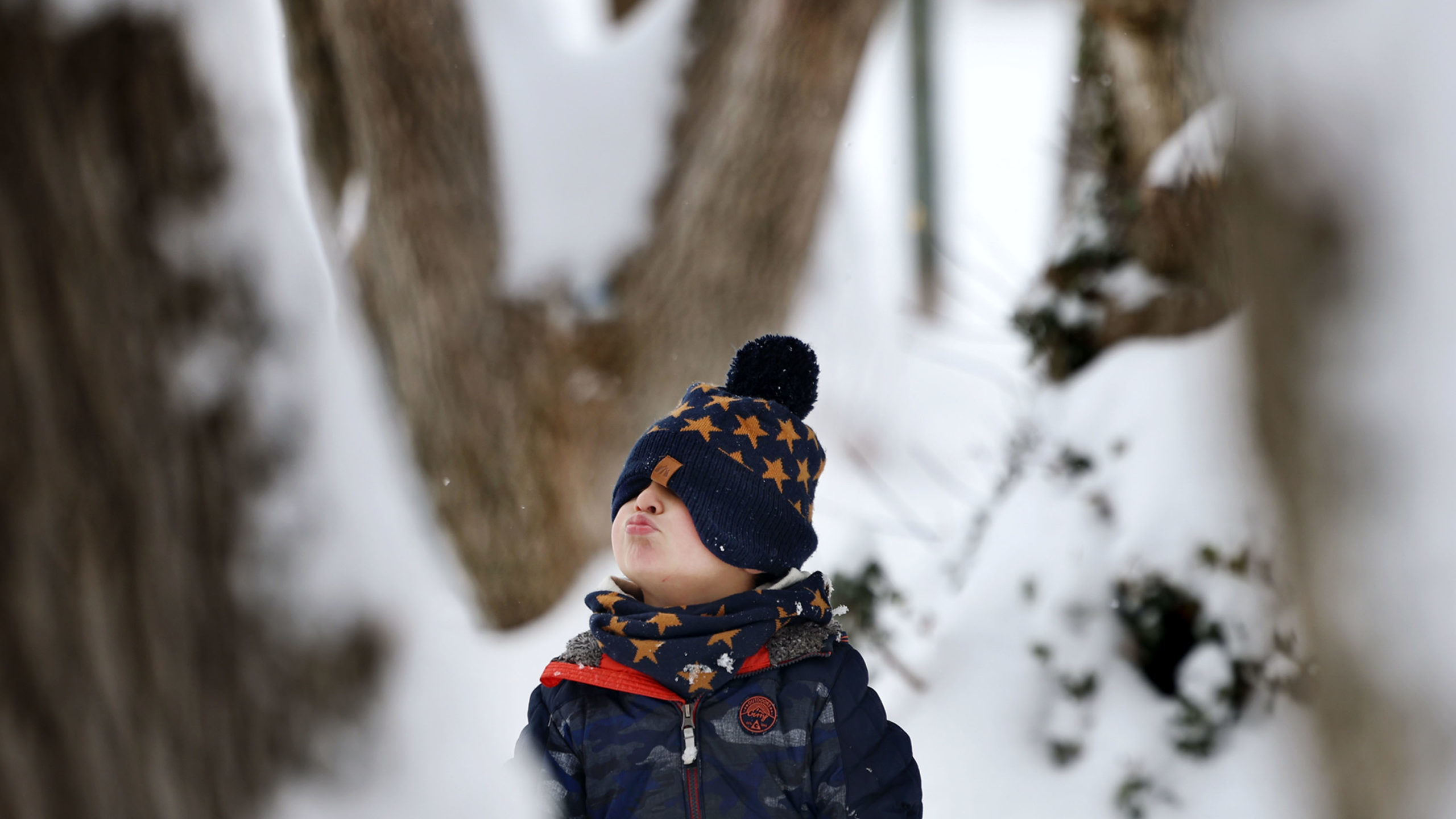 a child pictured outside in the snow during the day...