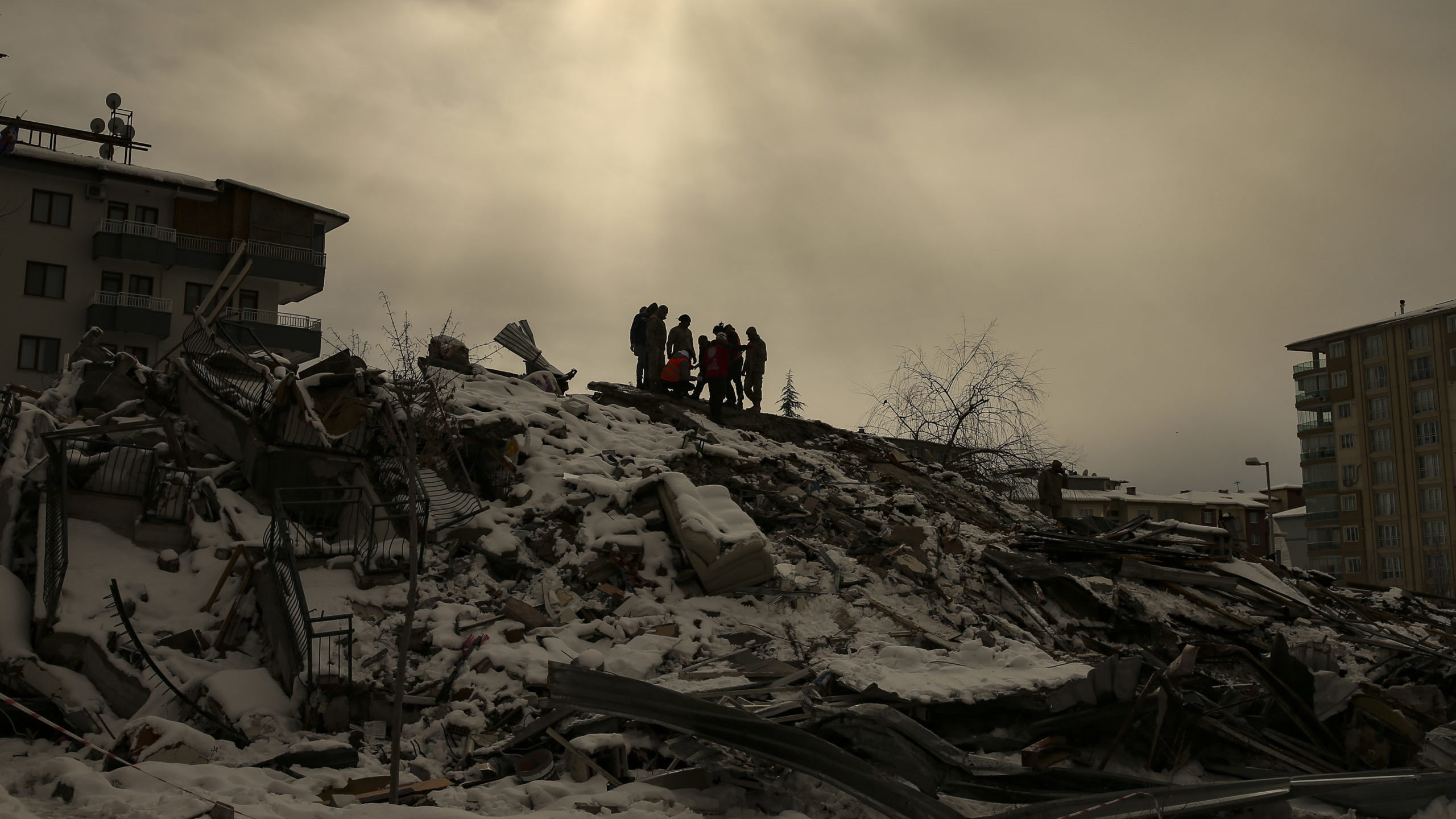 people are pictured searching the rubble following the turkey and syria earthquake...