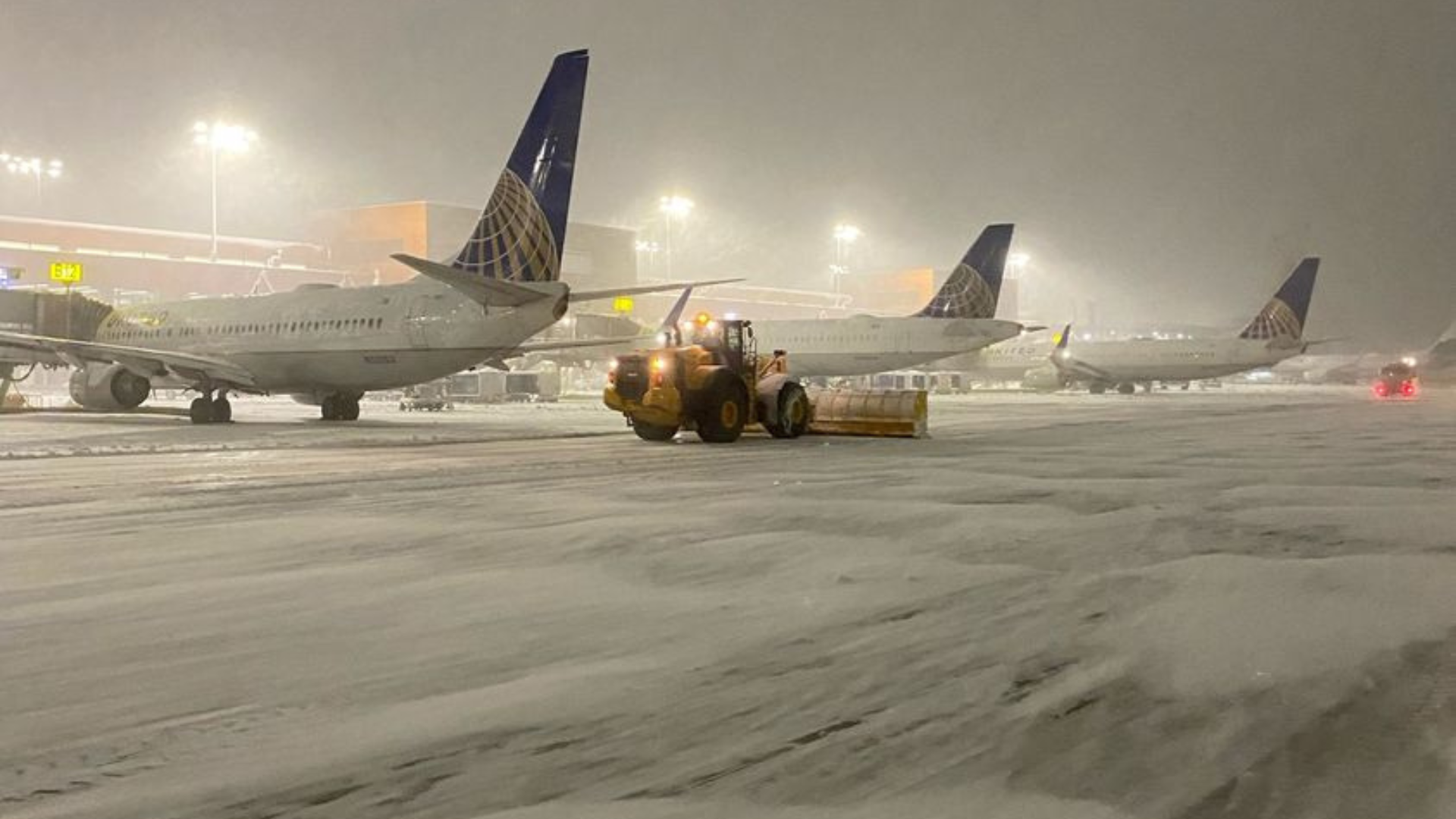 planes are hit by snow at the salt lake city international aiport...