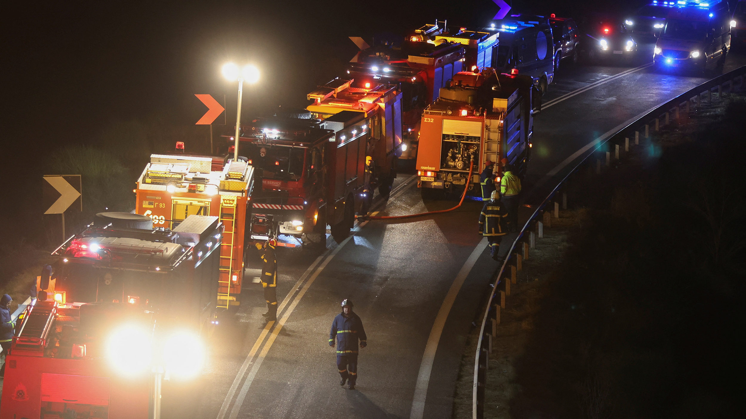 Firefighters attend the scene of the crash near the city of Larissa, Greece, on March 1. Photo cred...