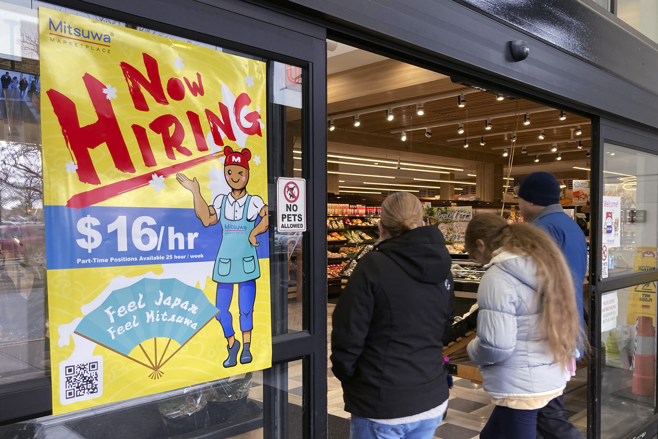 FILE - A hiring sign is displayed at a grocery store in Arlington Heights, Ill., Friday, Jan. 13, 2...