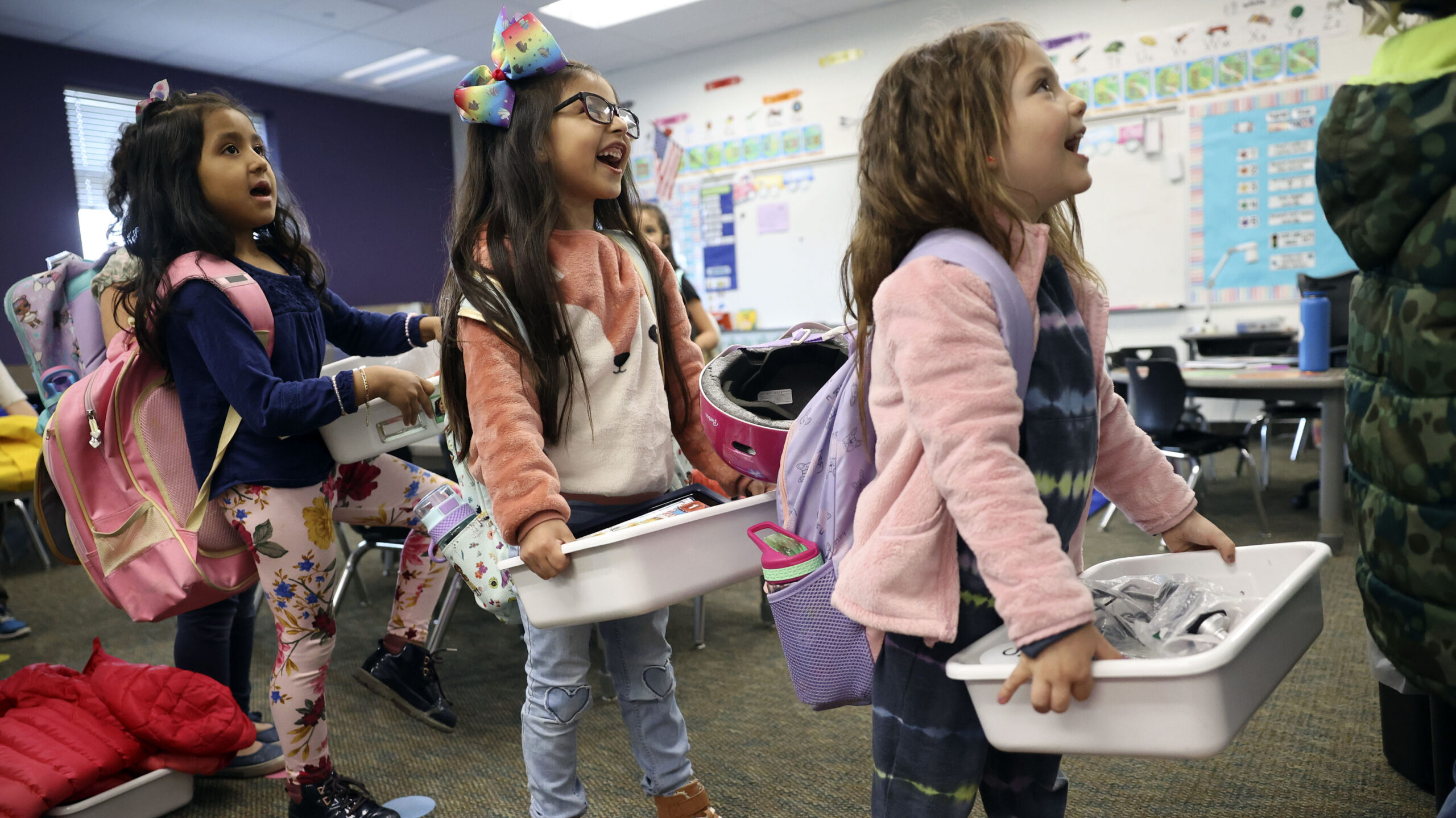 Children carrying totes in a classroom at Daniels Canyon Elementary School in Heber City on March 2...