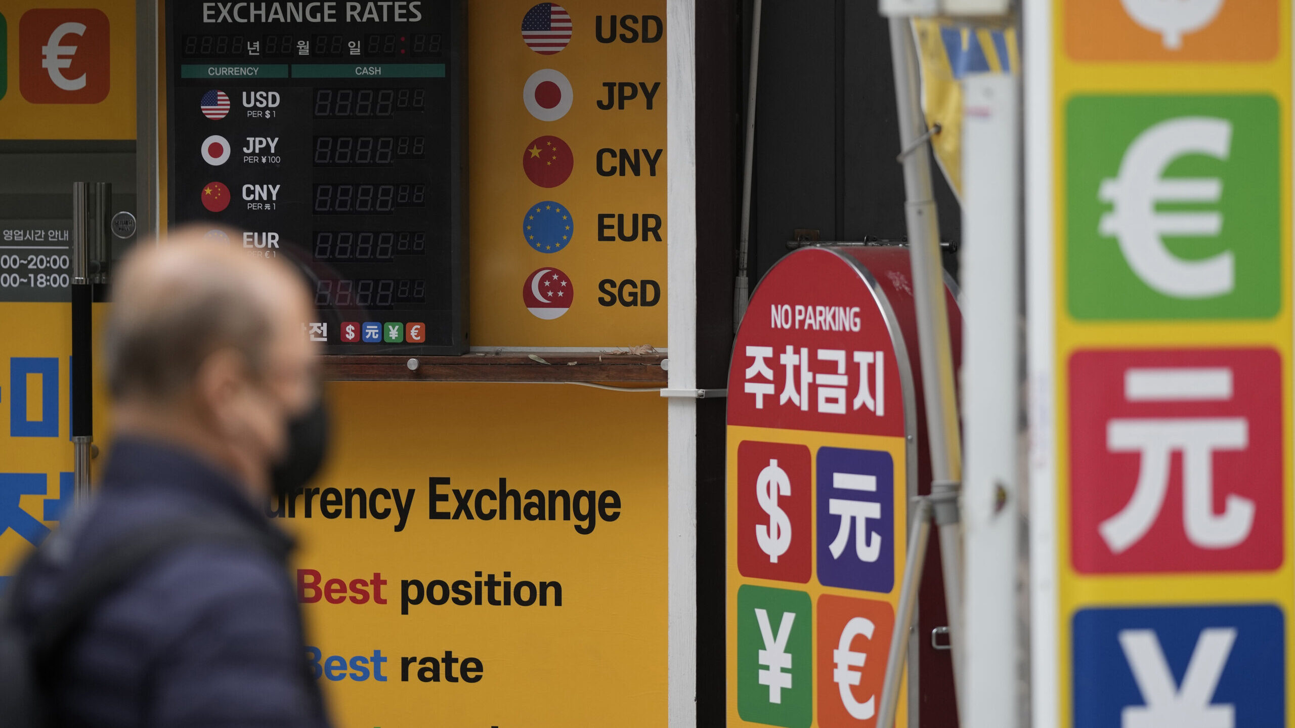 a man pictured next to currency exchange, rate hike expected today...