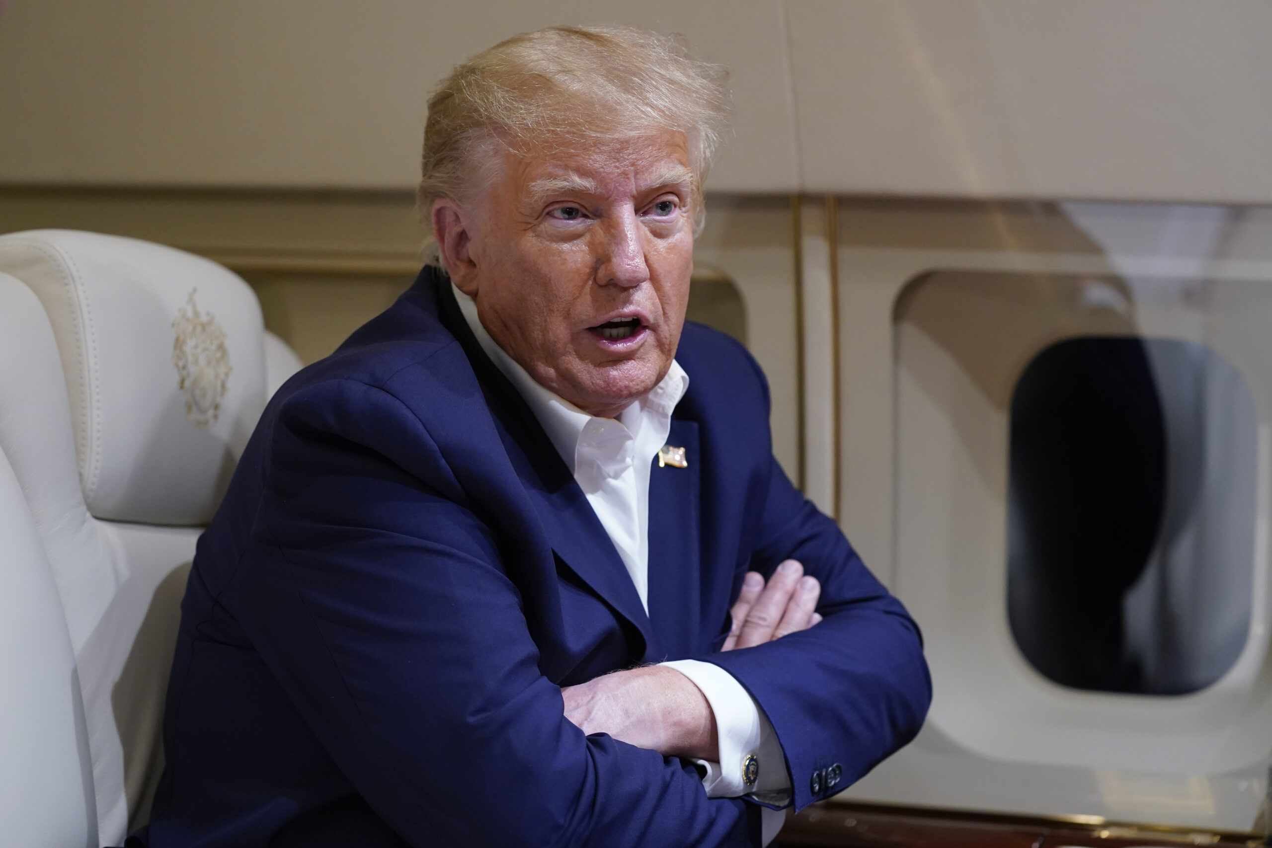 Former President Donald Trump speaks with reporters while in flight on his plane after a campaign r...