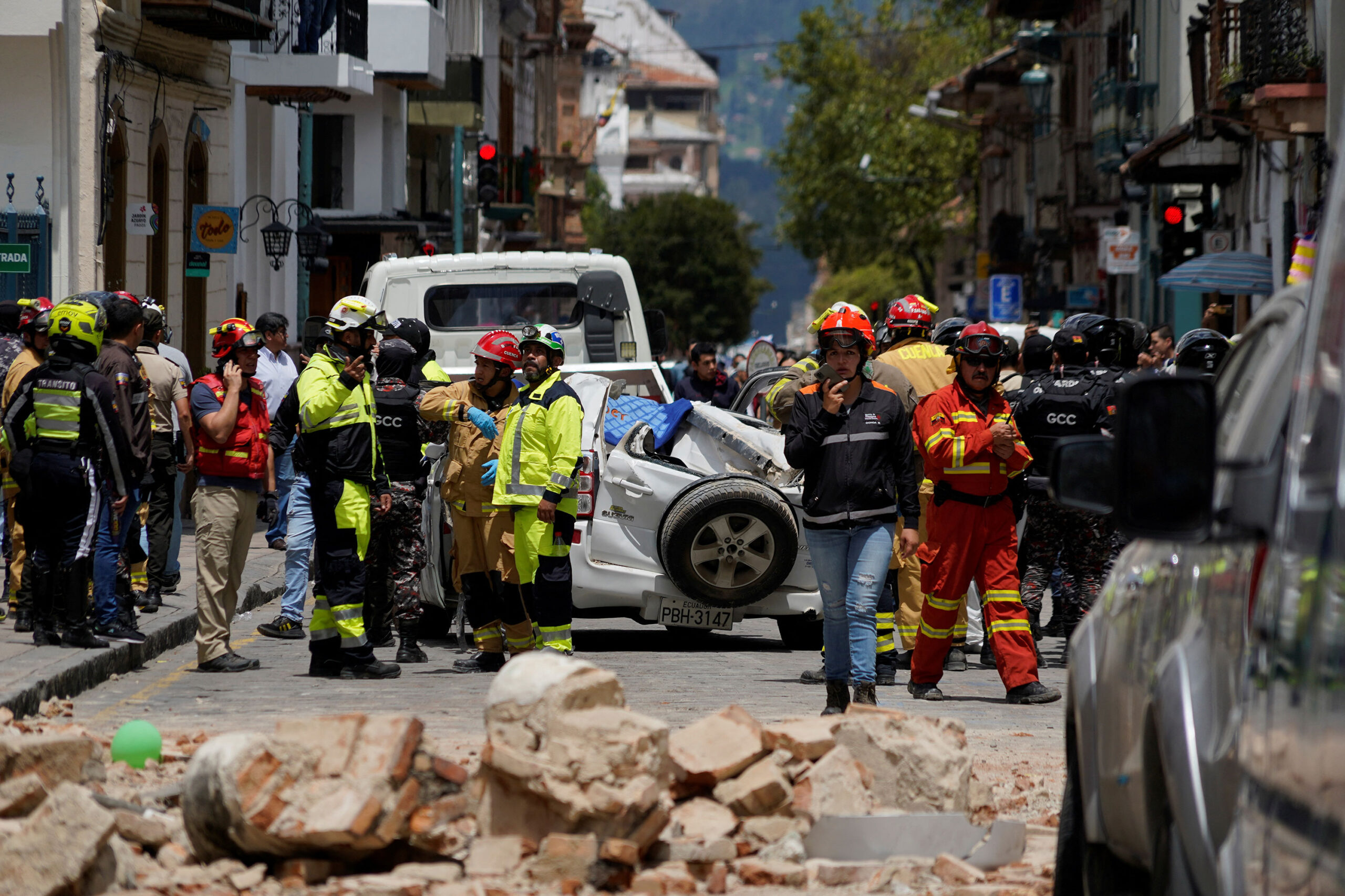 A damaged car and rubble from a house affected by the earthquake are pictured in Cuenca, Ecuador. M...