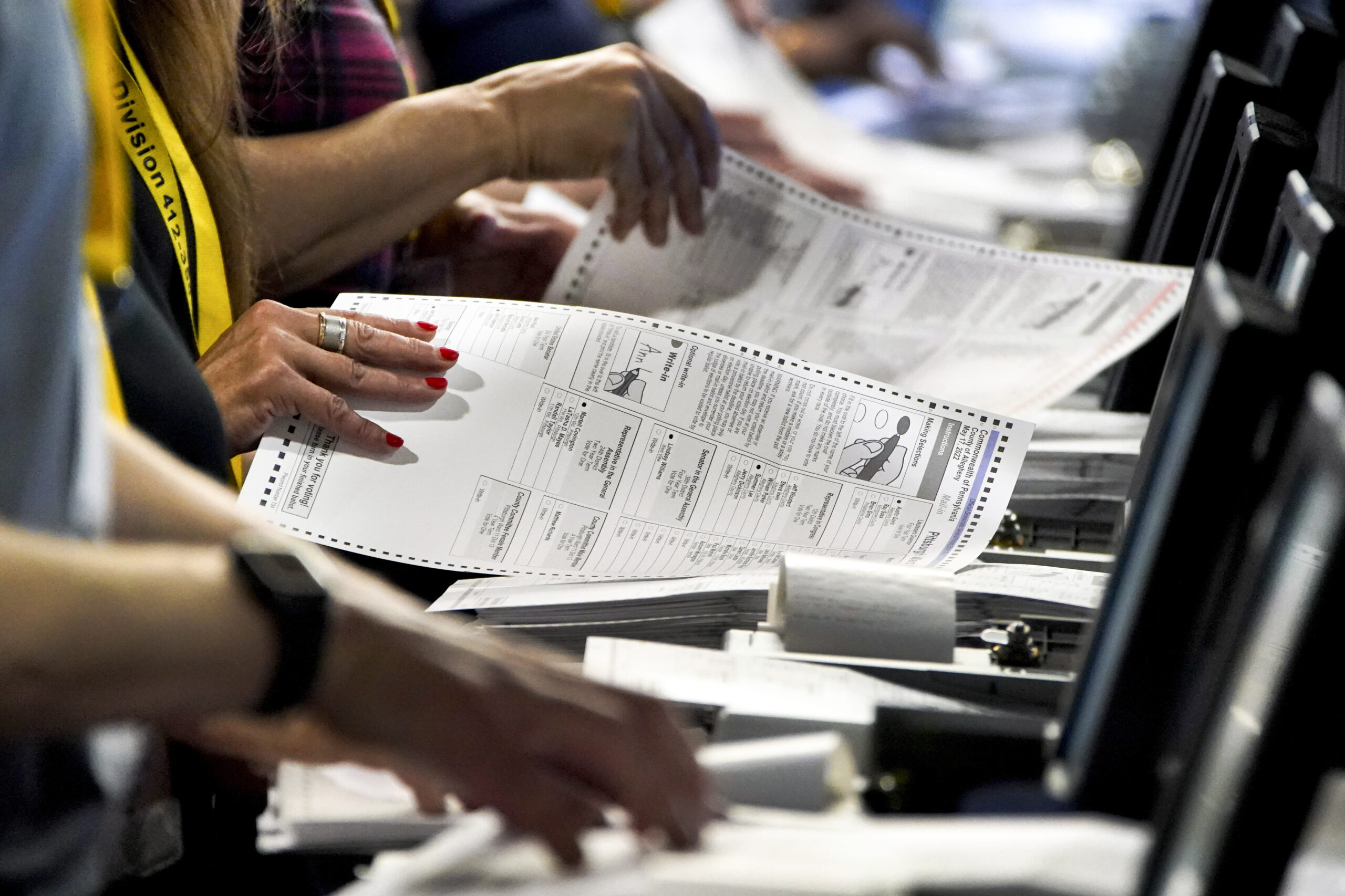 FILE - Election workers perform a recount of ballots from the Pennsylvania primary election at the ...