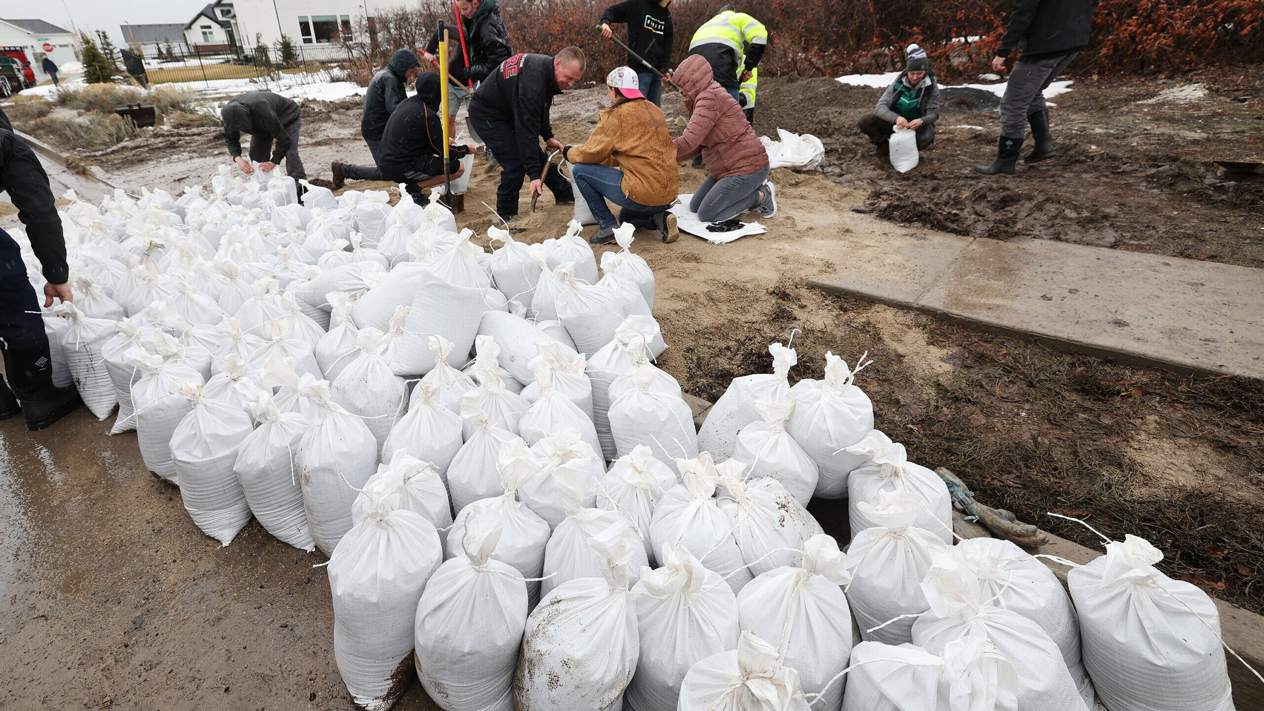 Volunteers and city employees fill sand bags due to flooding in Highland on Wednesday, March 15, 20...