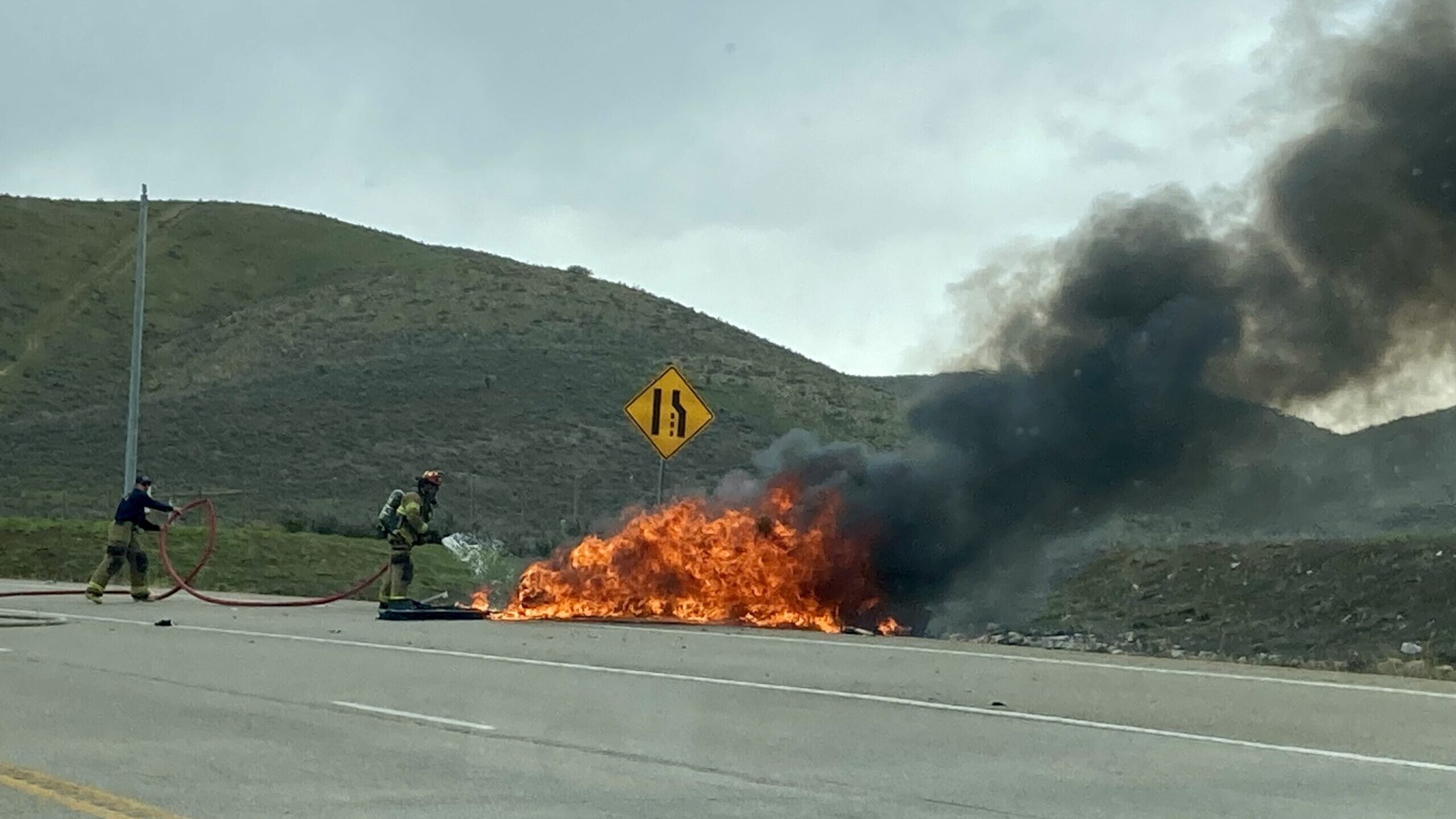 Fire crews work to put a fire from a fatal car crash on Tuesday on SR-189 near Wallsburg. Photo cre...