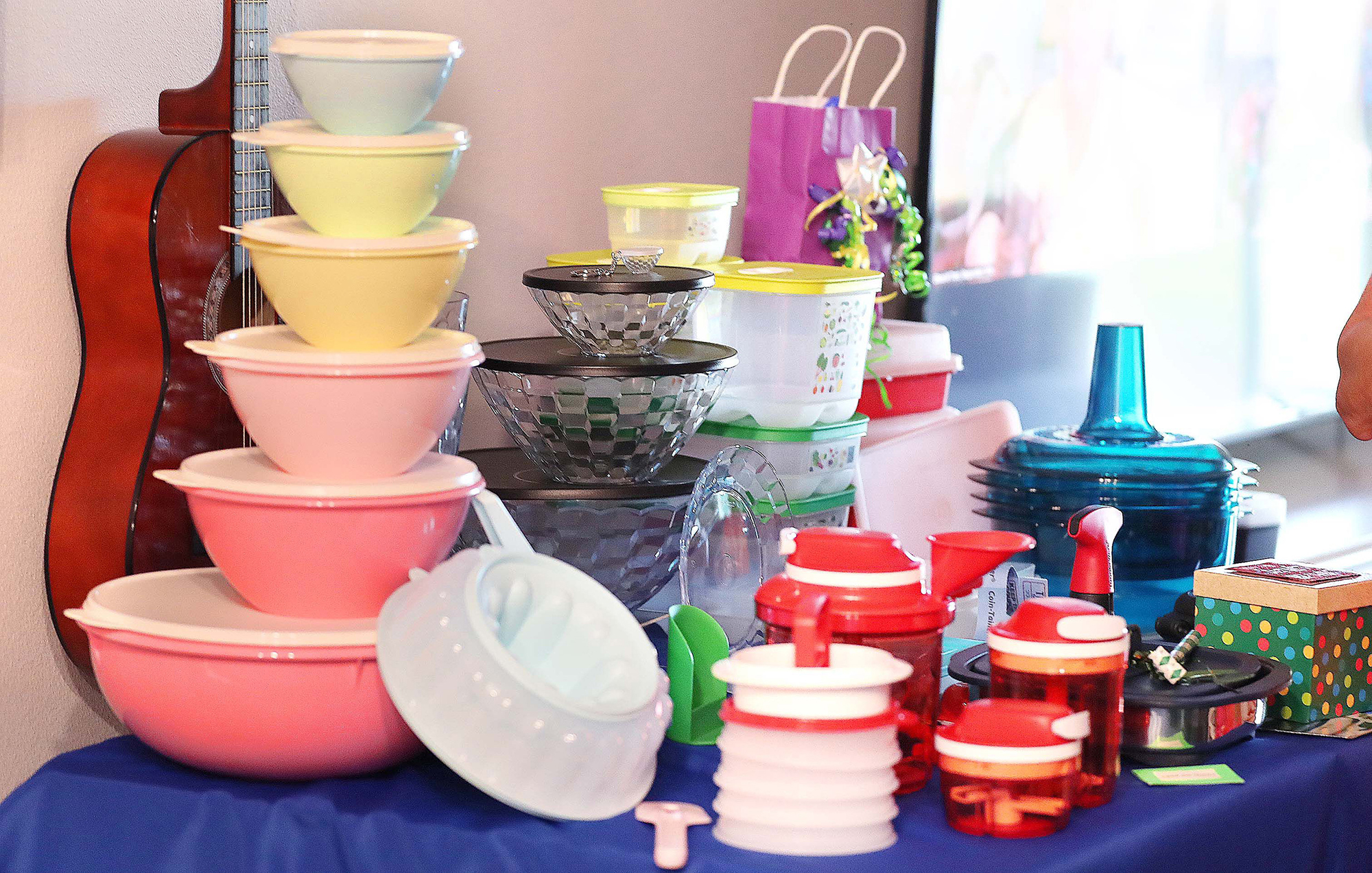 Tupperware items, including a set of "retro" storage containers at left, rest on a table ...