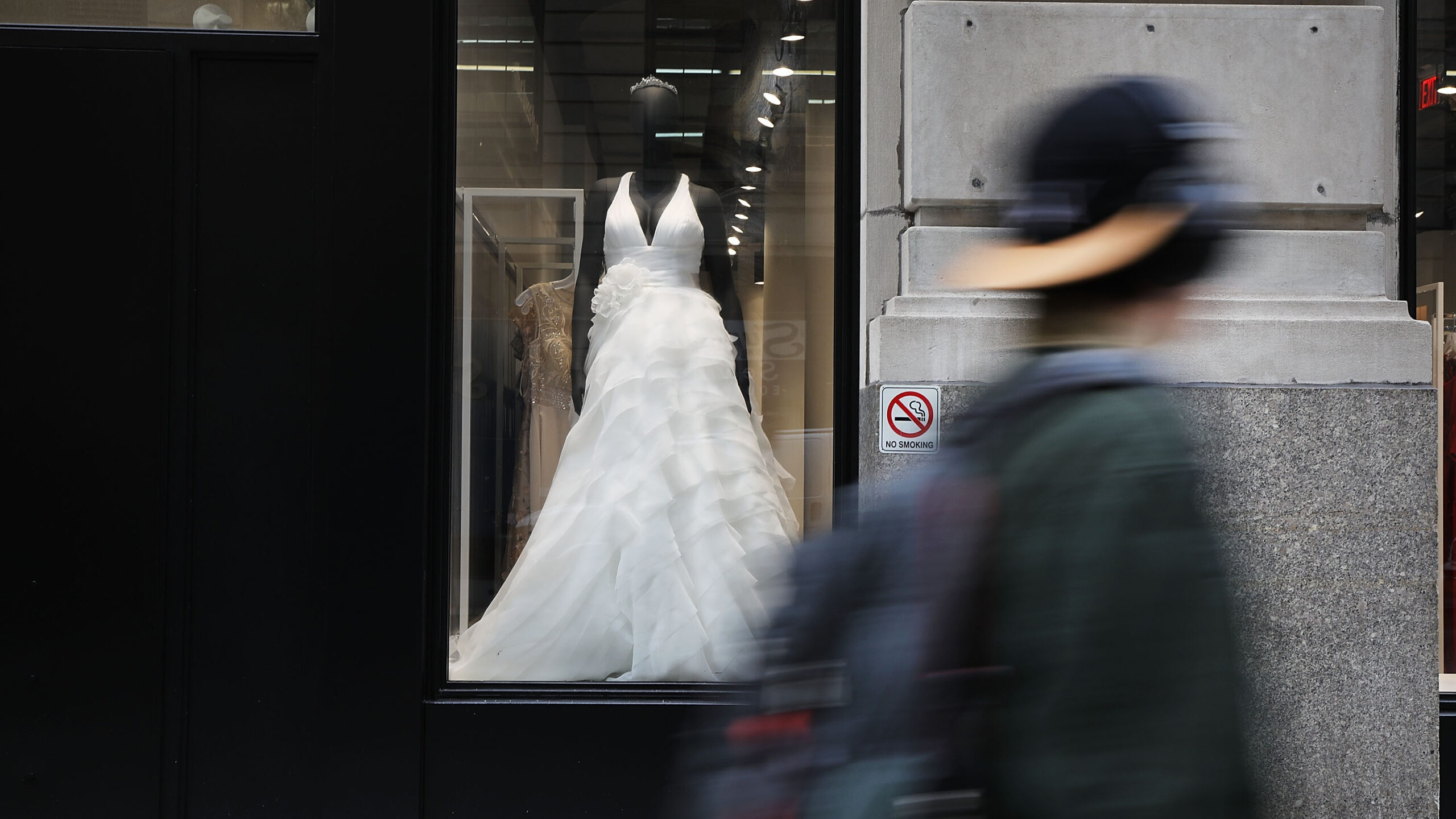 a person walks past a david's bridal shop window...