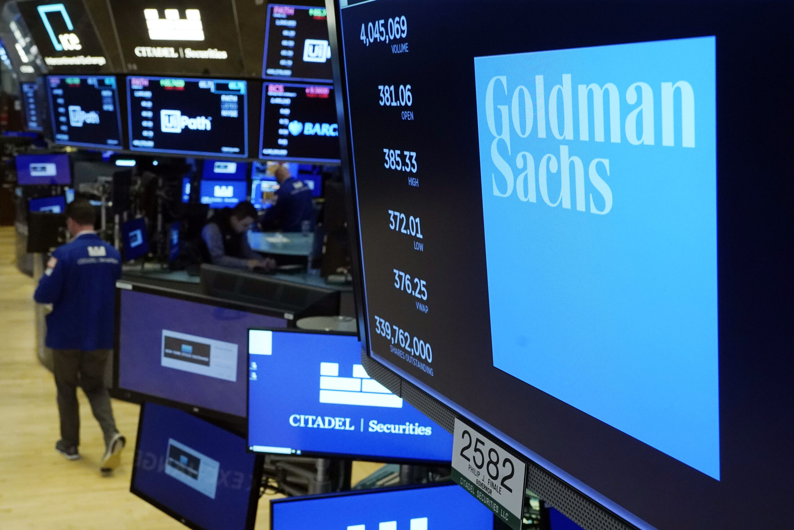 FILE - The logo for Goldman Sachs appears above a trading post on the floor of the New York Stock E...