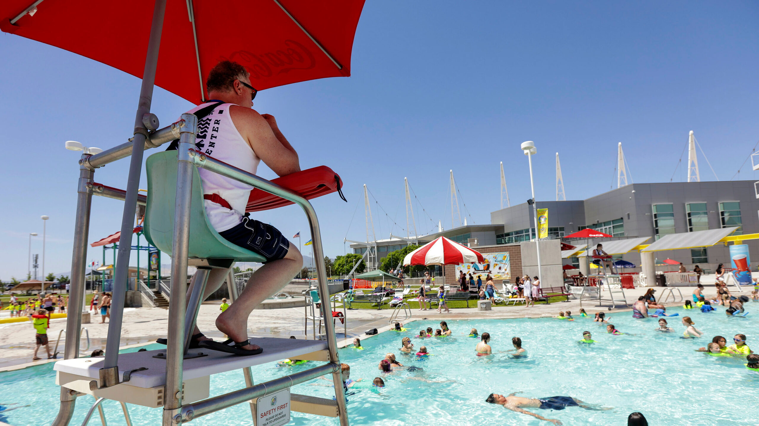 Photo of a lifeguard at an outdoor pool in Kearns, Utah. With a global average temperature of 62 de...