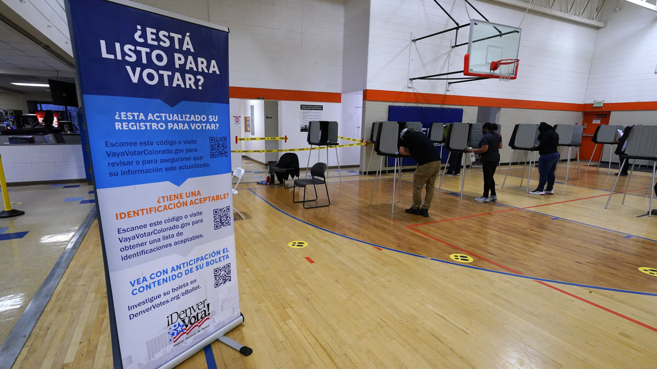 a sign in spanish lists requirements to vote, latino voters are a target for misinformation...