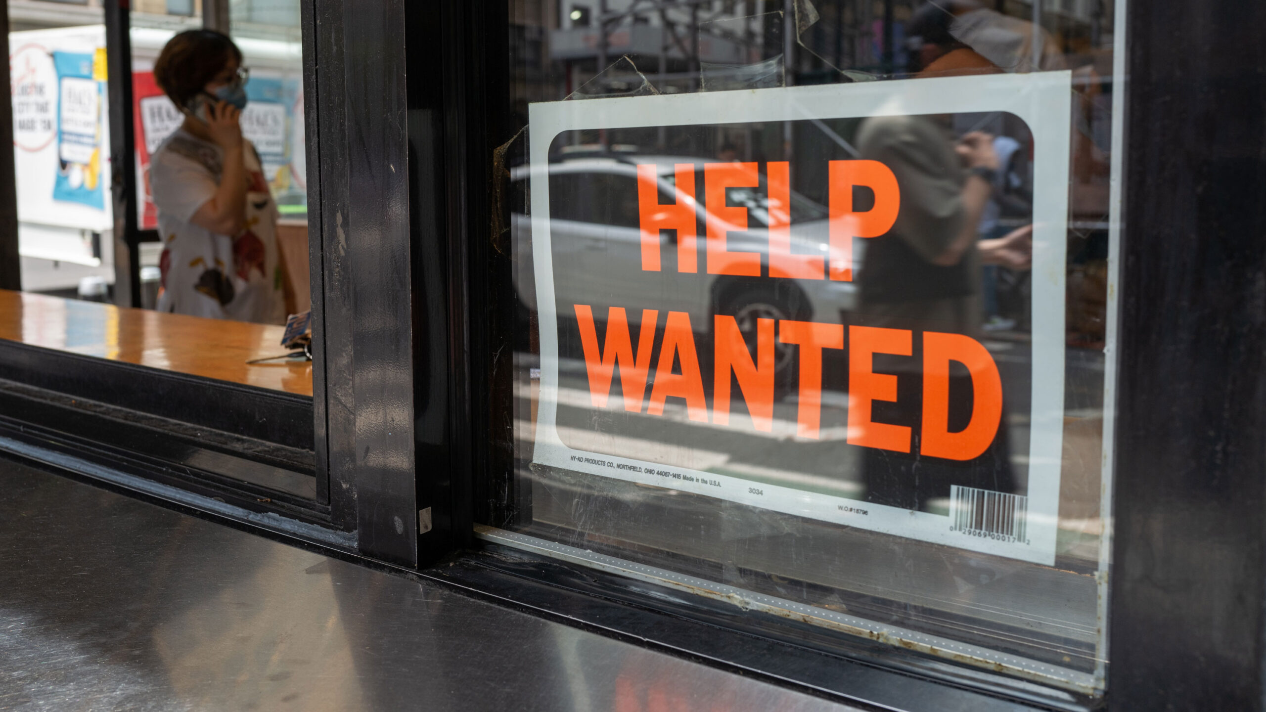 NEW YORK, NEW YORK - JULY 28: A "help wanted" sign is displayed in a window in Manhattan on July 28...