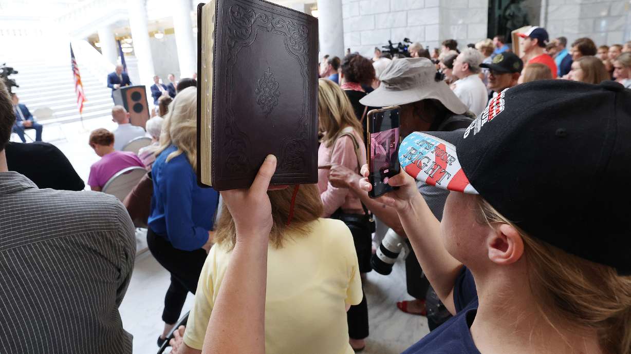 A Bible is held at a rally at the Capitol in Salt Lake City on June 7 to voice concern regarding th...