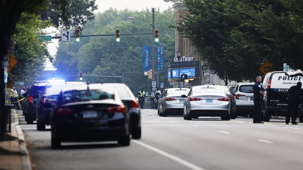 Cars and police gather around Altria Theater, the site of a shooting at the Huguenot High School gr...