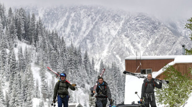 Backcountry skiers Jake Turnbull, left, Santiago Vega and Jason Malczyk walk back to their cars aft...