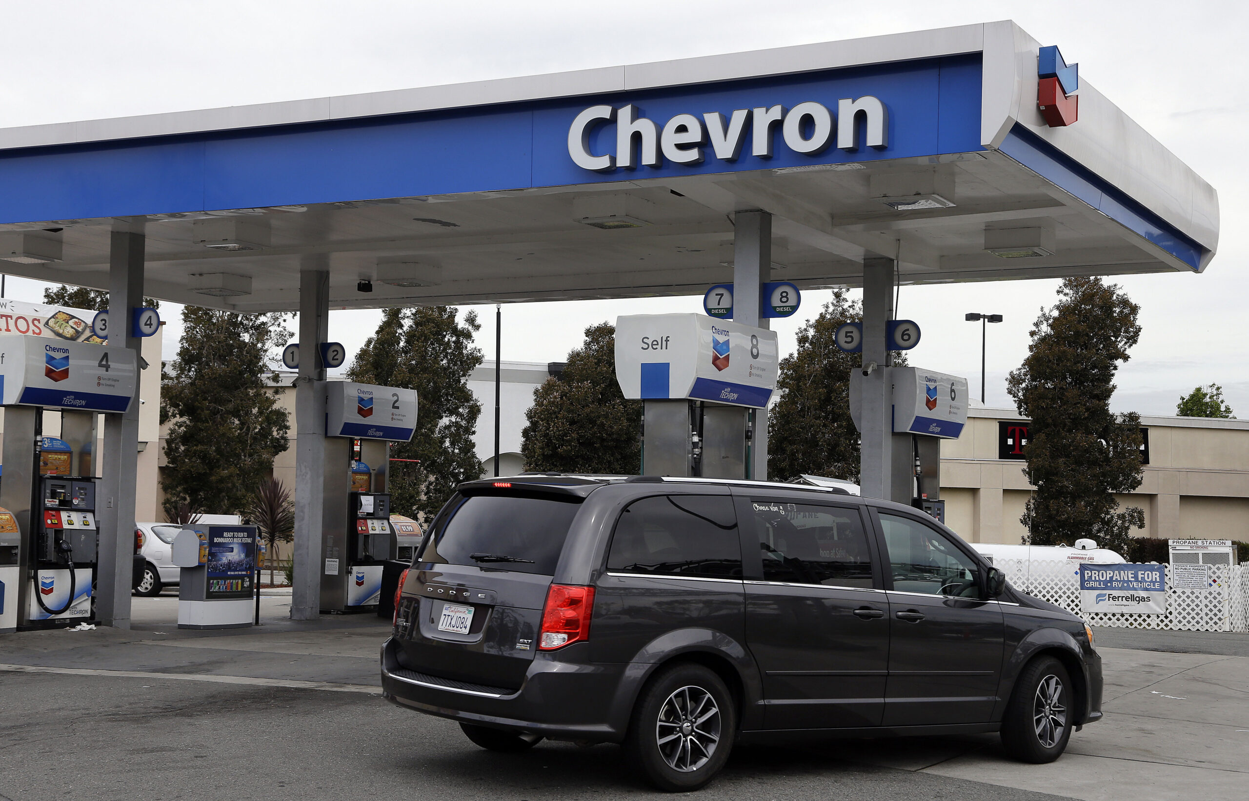 FILE - A motorist drives near the pumps at a Chevron gas station in Oakland, Calif. Tuesday, April ...