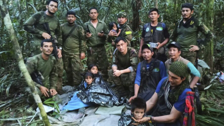 In this photo released by Colombia's Armed Forces Press Office, soldiers and Indigenous men pose fo...