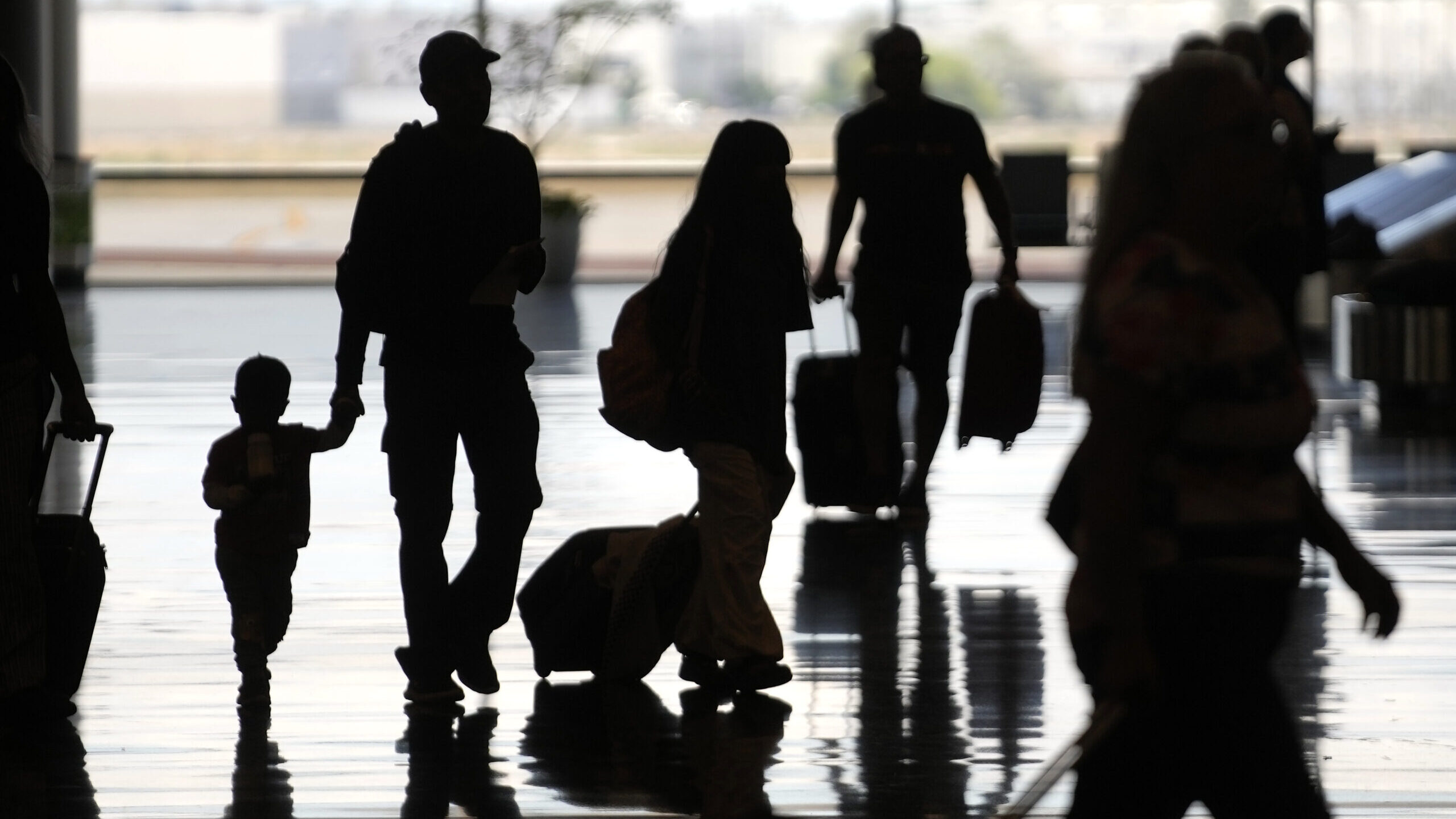 People travel through Salt Lake City International Airport Friday, June 30, 2023, in Salt Lake City...