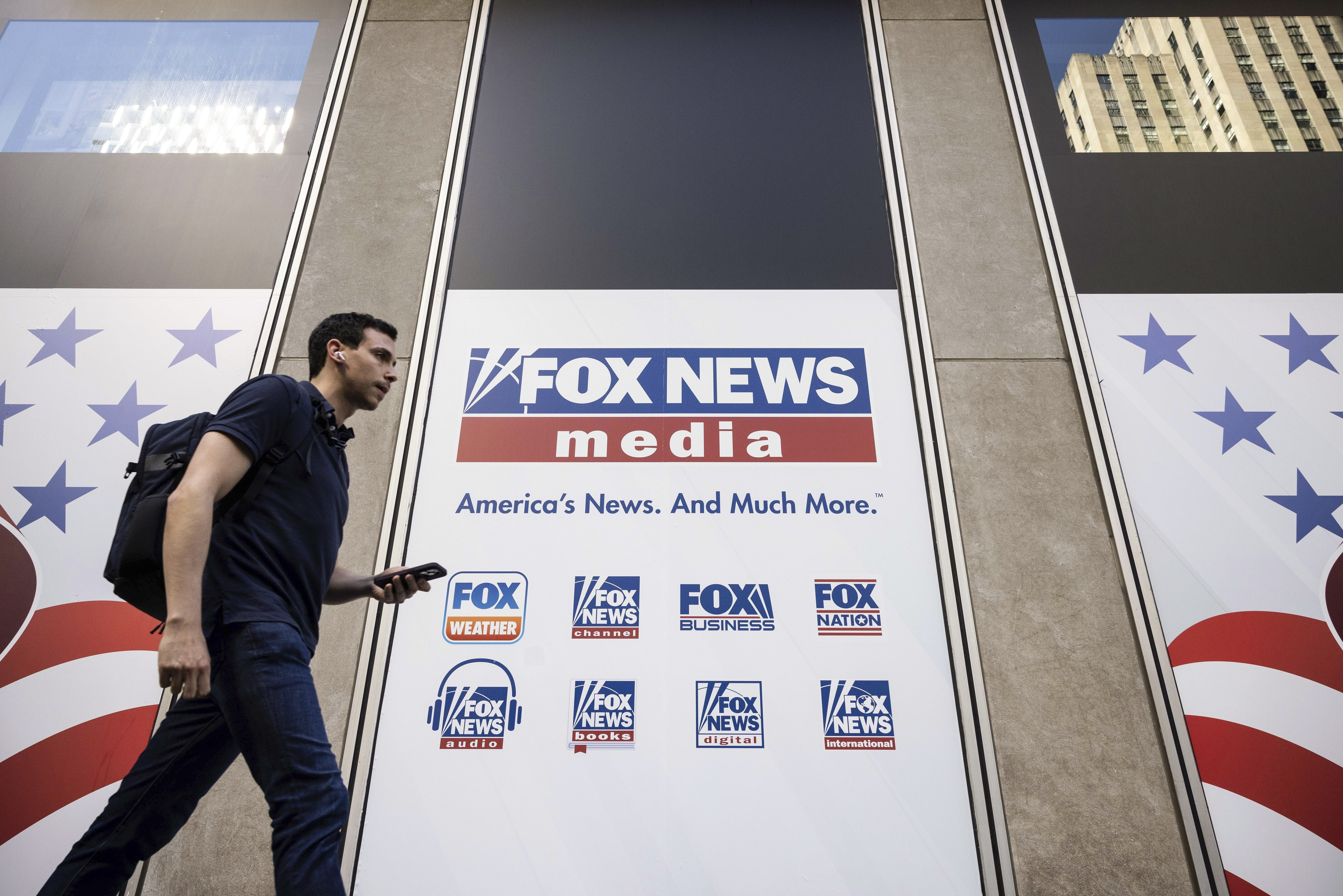FILE - A person walks past the Fox News Headquarters in New York on April 12, 2023. Fox News will p...