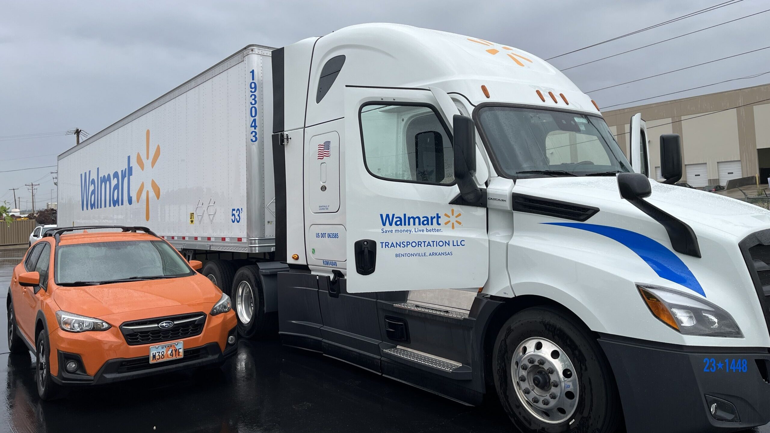 a semi truck is pictured next to a regular car, officials are urging semi truck safety...