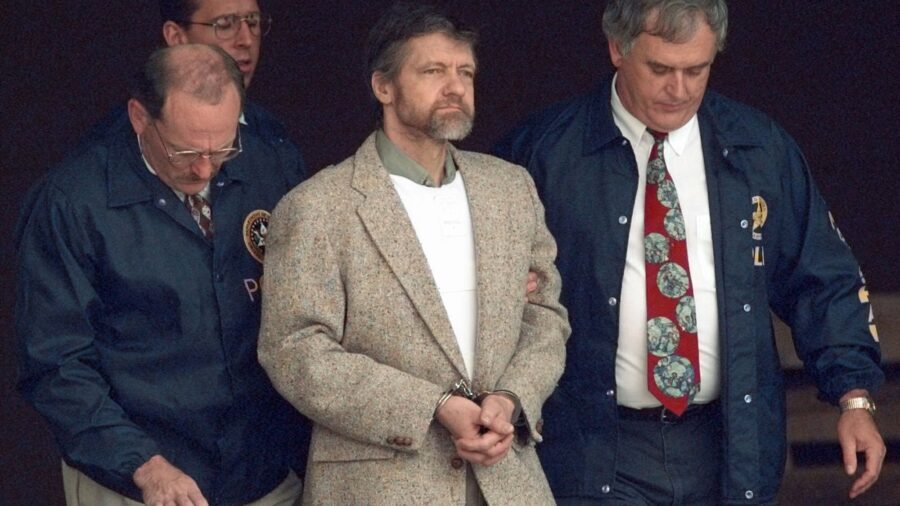 FILE - Theodore Kaczynski looks around as U.S. Marshals prepare to take him down the steps at the f...