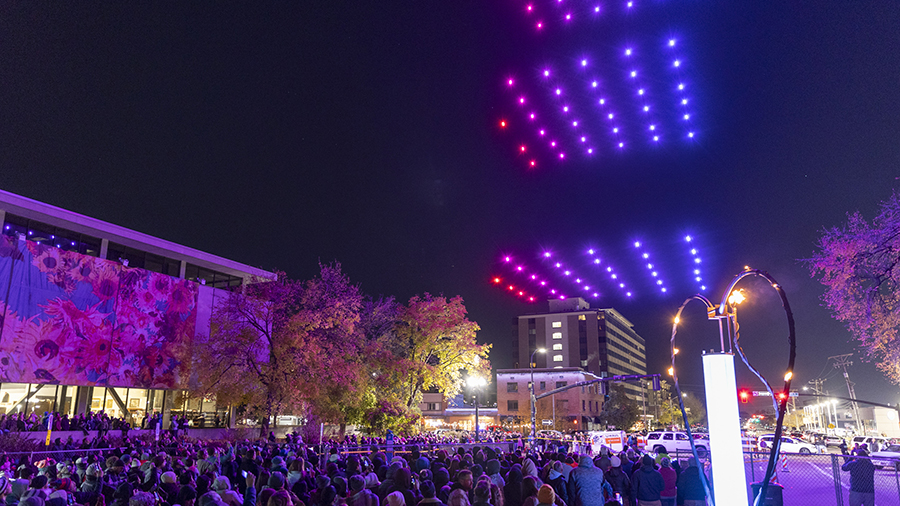 Attendees watch as 150 drones perform over them at ILLUMINATE: Light Art + Creative Tech Fest in Sa...