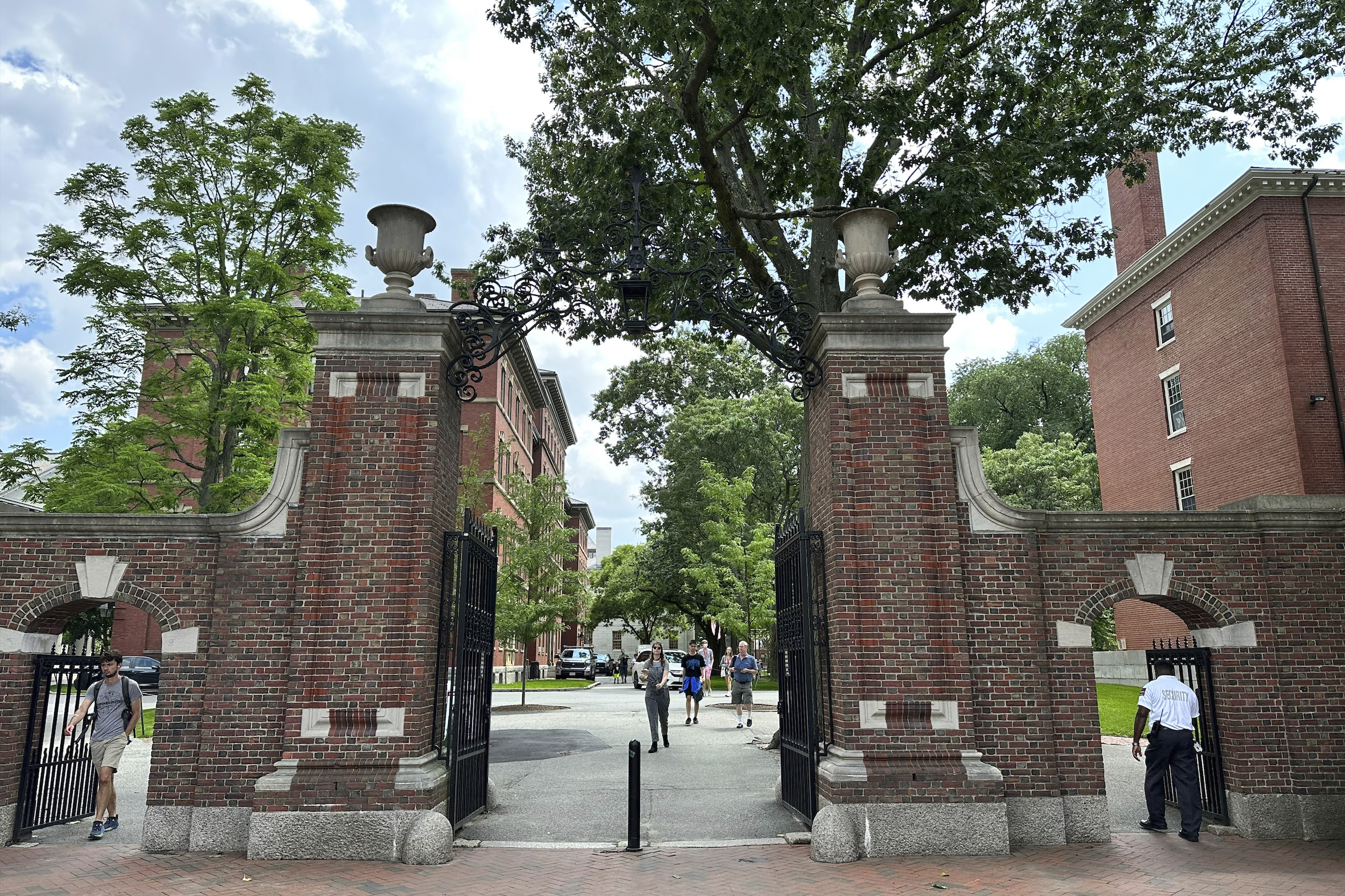 Students walk through a gate at Harvard University, Thursday, June 29, 2023, in Cambridge, Mass. Th...