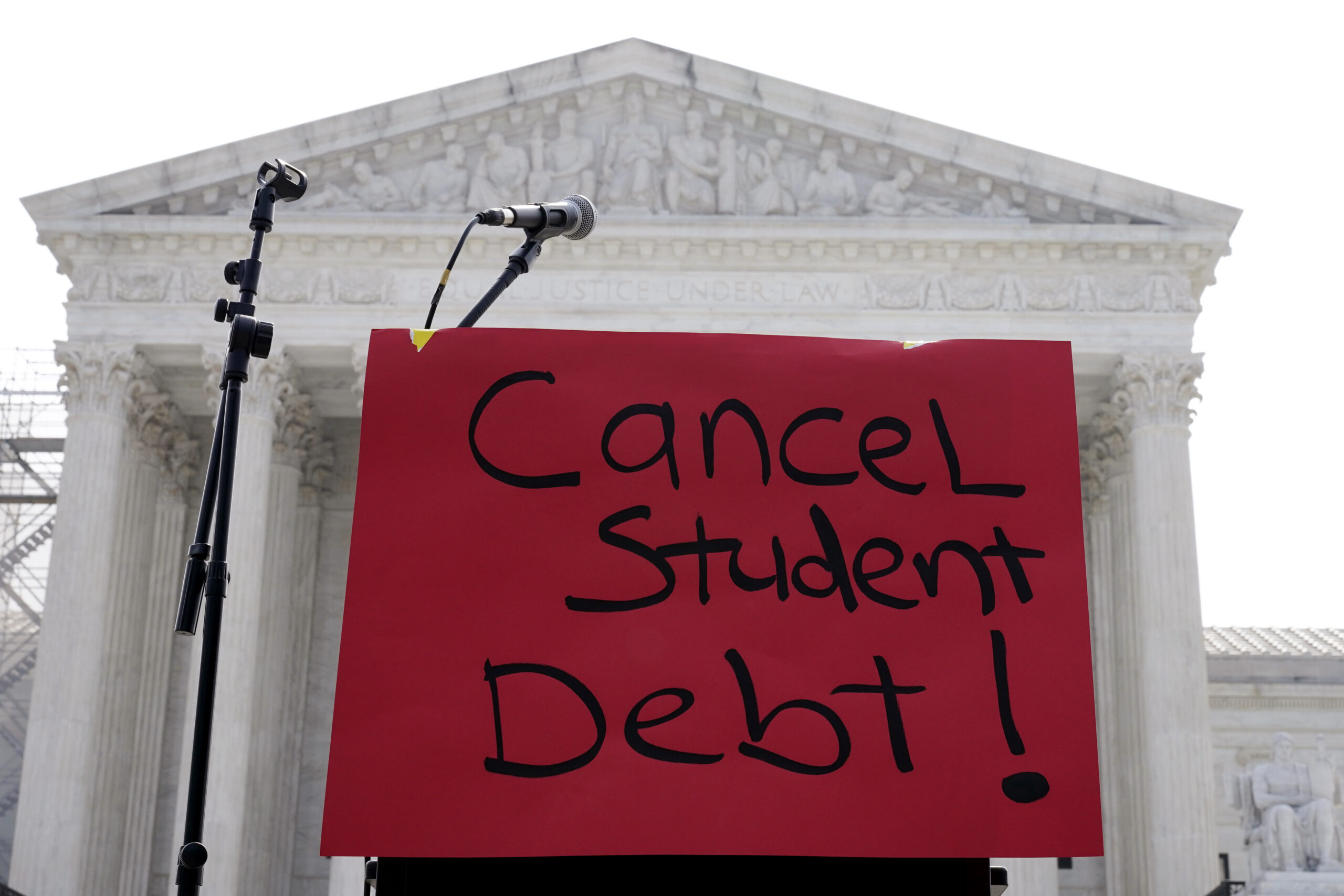 A sign reading "cancel student debt" is seen outside the Supreme Court, Friday, June 30, 2023, in W...