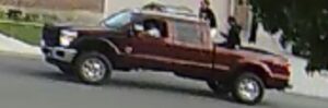 a blurry photo shows teens in a large red truck that are suspected of a water balloon assault in springville