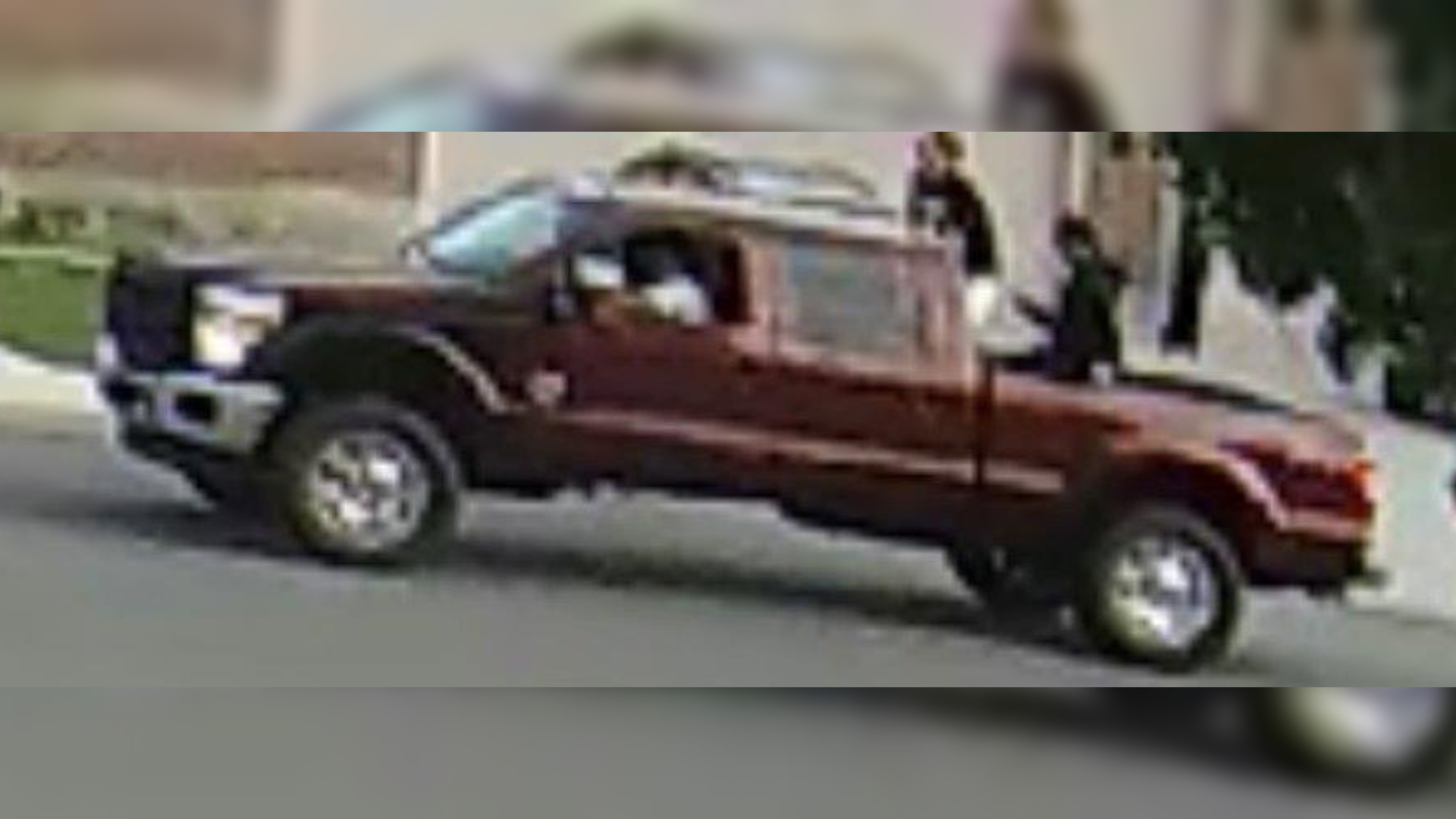 a blurry photo shows teens in a large red truck that are suspected of a water balloon assault in sp...