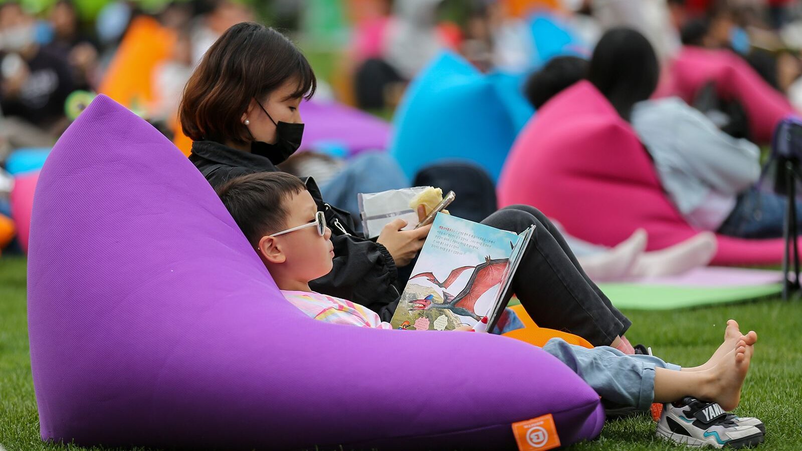 A child reads a book at Seoul Plaza in Seoul, South Korea, on April 23. Photo credit: 	Wang Yiliang...