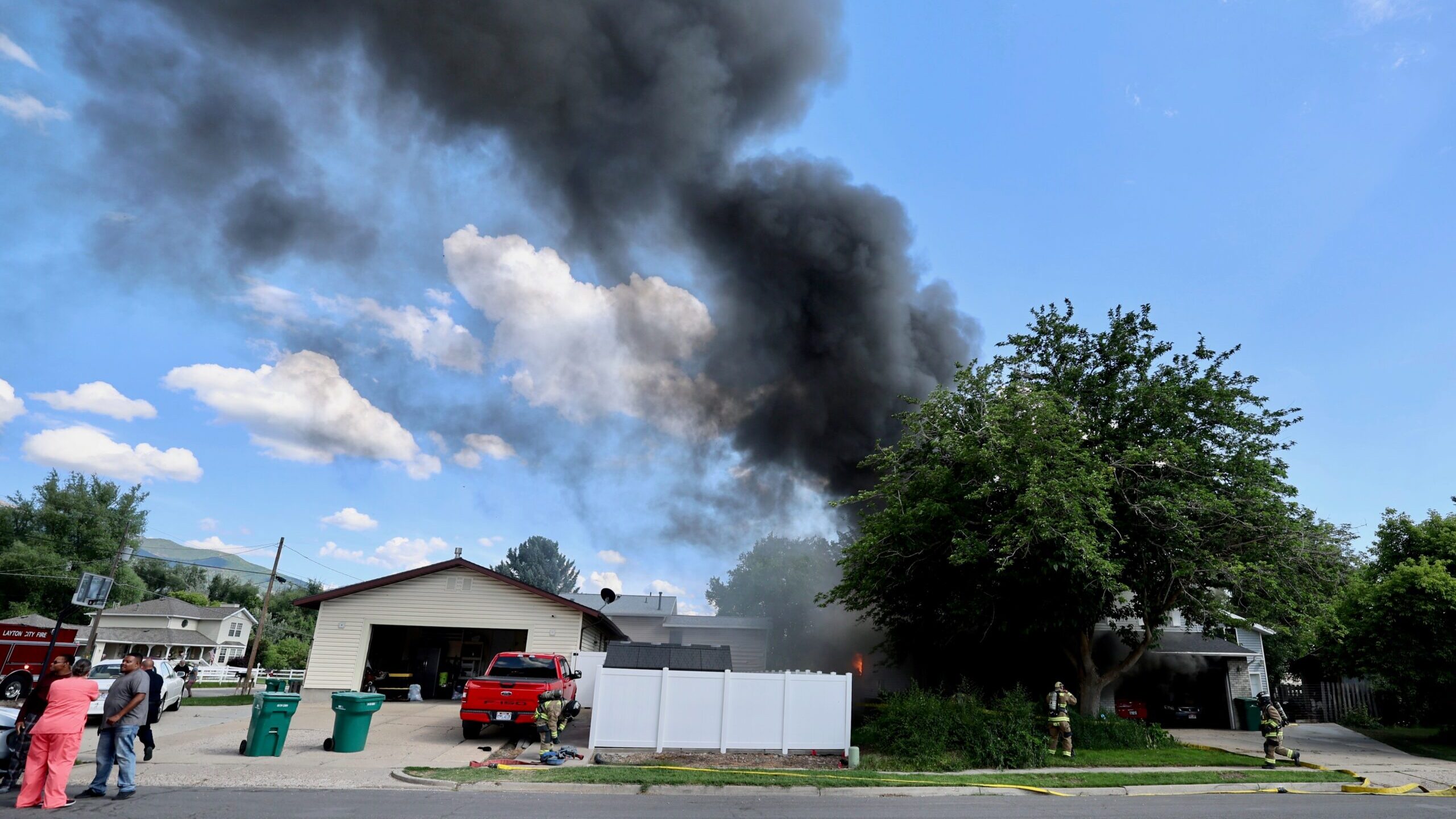 Three occupants of a house in Layton made it out safely after the house caught fire on Tuesday afte...