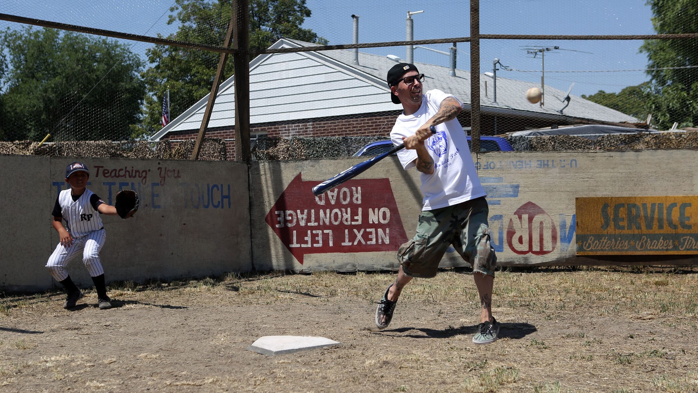 Nathan Espinoza catches as Chauncey Leopardi, who played Squints in "The Sandlot," hits the ball on...