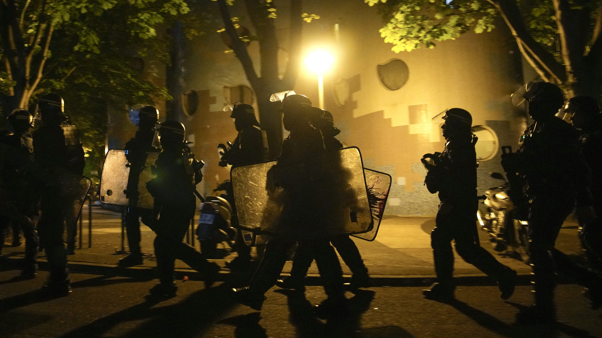 NANTERRE, France (AP) — Young rioters clashed with police and looted stores overnight Friday in a...