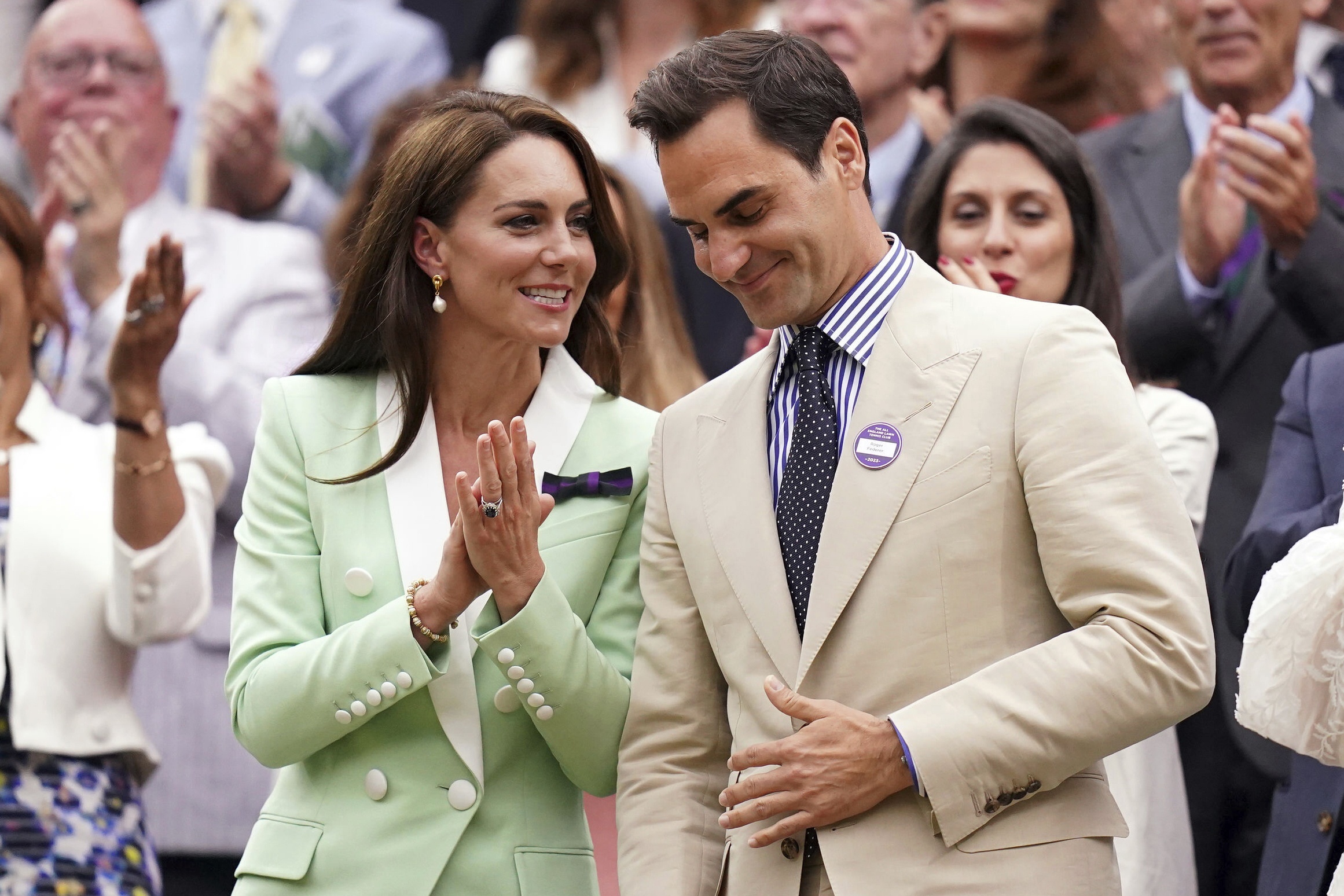 Britain's Kate, Princess of Wales, left, shares a word with tennis champion Roger Federer in the ro...